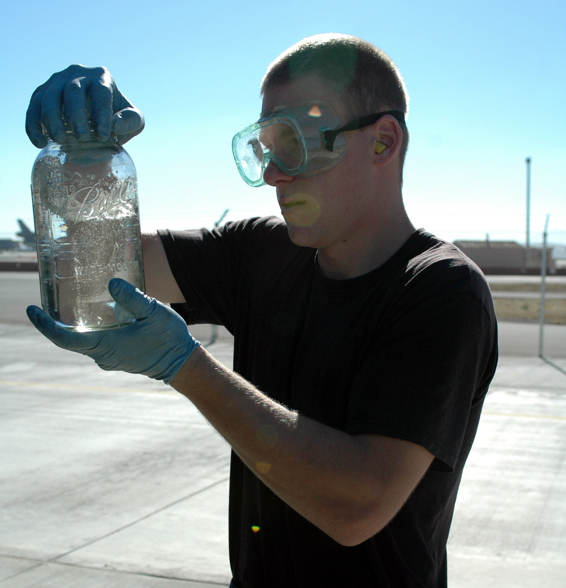 Airman 1st Class Kyle Newcombe, 60th Logistics Readiness Squadron, Fuels Management Flight, visually checks for fuel impurities. The flight will be evaluated on all facets of fuel operations, including receiving products into storage tanks, verifying product quality and the upkeep of facilities, equipment and vehicles. (U.S. Air Force photo by Tech. Sgt. Donald Osborn/ 60th Air Mobility Wing Public Affairs)