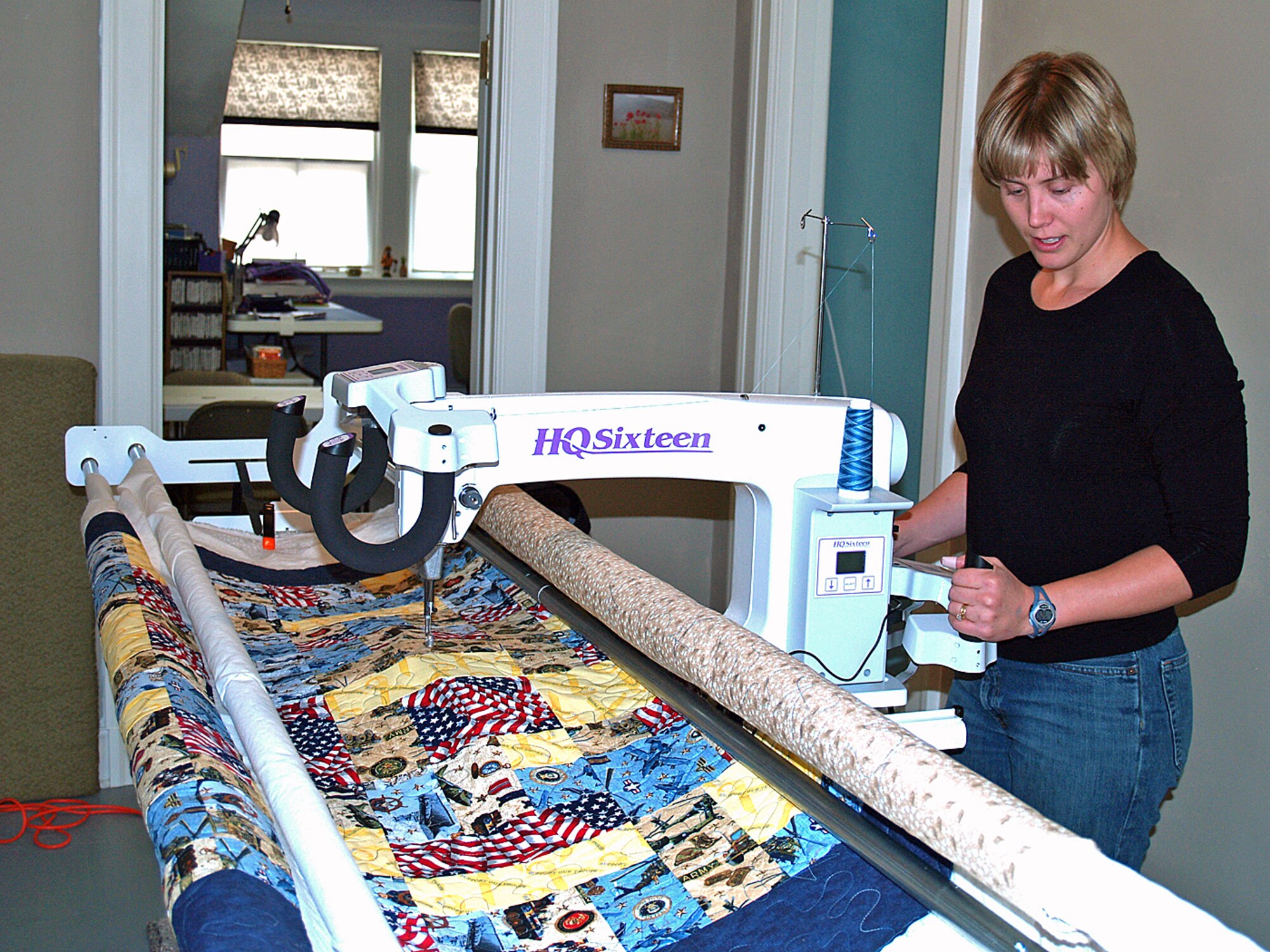 Tana Angerman, wife of Maj. Scott Angerman, works on her quilt on Electra, a 10-foot mid-arm quilting machine, in her home recently.  This quilt, and many like it, will be given to combat-wounded servicemembers in the Global War on Terror through the Quilts of Valor organization.