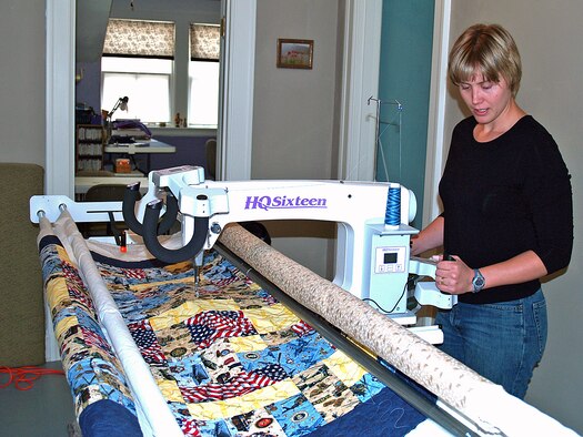 Tana Angerman, wife of Maj. Scott Angerman, works on her quilt on Electra, a 10-foot mid-arm quilting machine, in her home recently.  This quilt, and many like it, will be given to combat-wounded servicemembers in the Global War on Terror through the Quilts of Valor organization.
