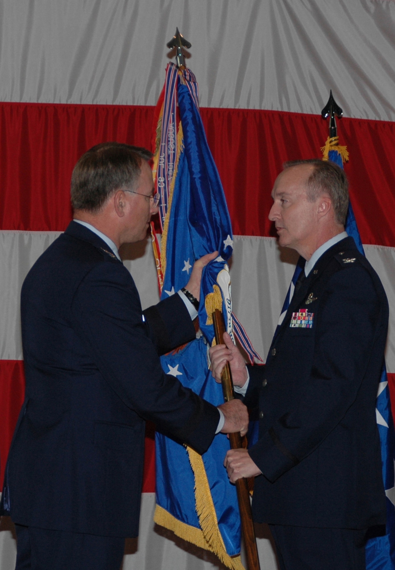 Lt. Gen. John Bradley, commander of Air Force Reserve Command and chief of the Air Force Reserve, hands the flag off to Col. Ed Walker, who assumes command of the 917th Wing Saturday, Nov. 4, in a ceremony held at Hoban Hall, Barksdale AFB, La. (U.S. Air Force photo/Tech. Sgt. Jeff Walston)