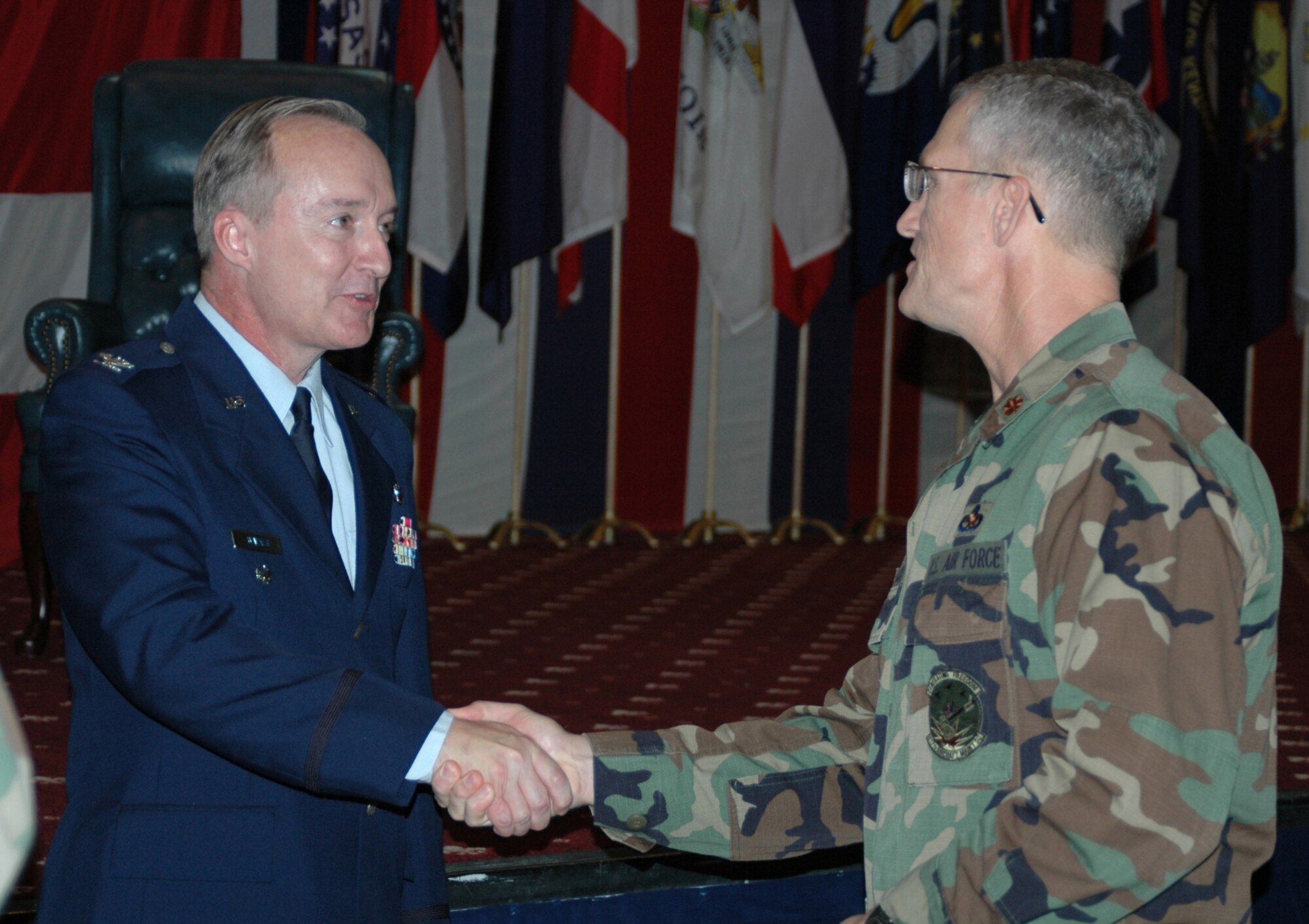 Col. Ed Walker, new 917th Wing commander, shakes the hand of Maj. Dwayne Slack, 917th Aircraft Maintenance Squadron commander, following the Wing change of command ceremony held Saturday, Nov. 4, at Hoban Hall, Barksdale AFB, La. (U.S. Air Force photo/Tech. Sgt. Jeff Walston)