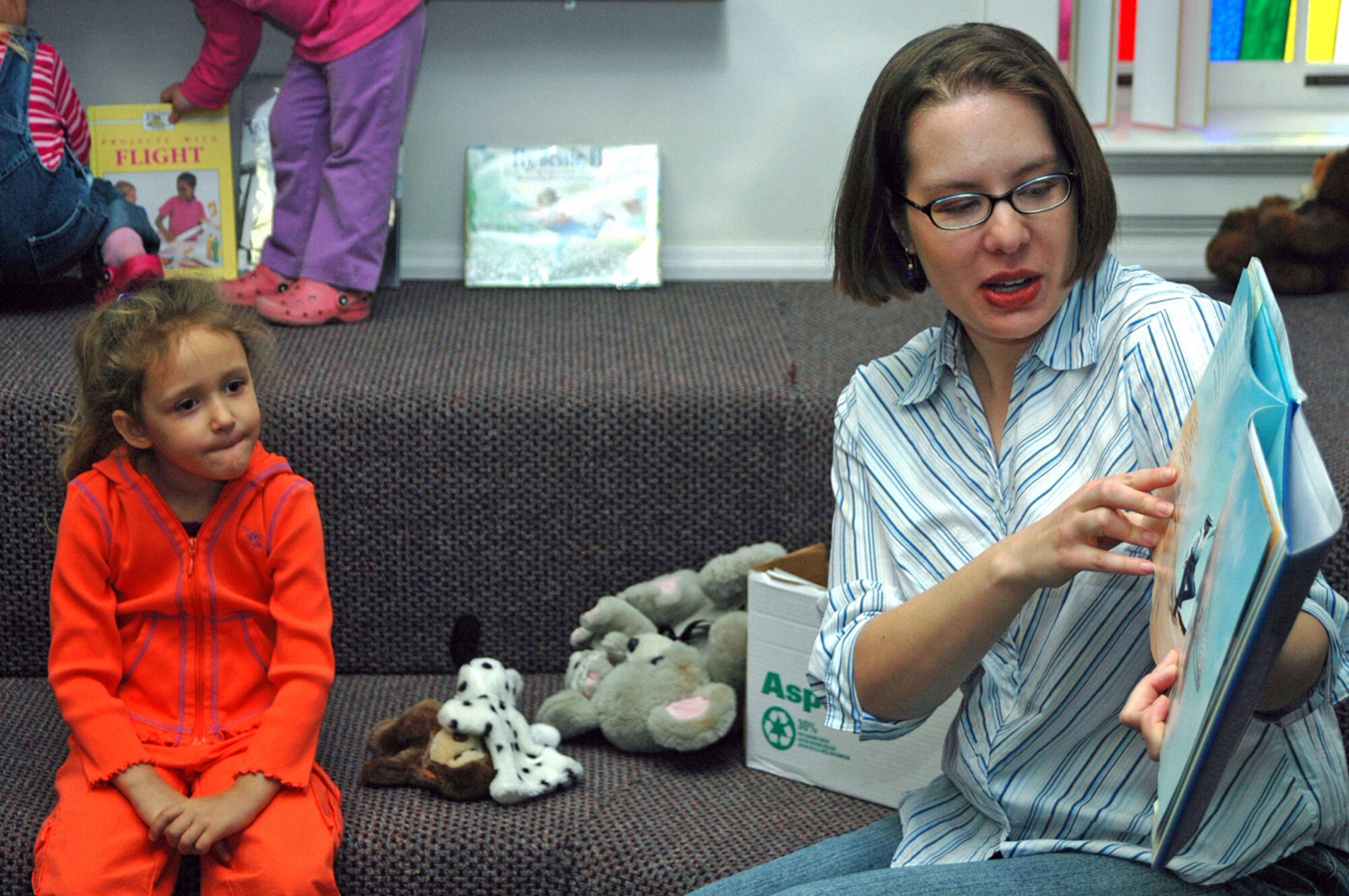 Katelyn Mann listens to a story about Orville and Wilbur Wright during storytime in the Warren library Nov. 3. Children's Story Hour is held every Friday at 11 a.m. in the base library and includes reading and other activities for children.