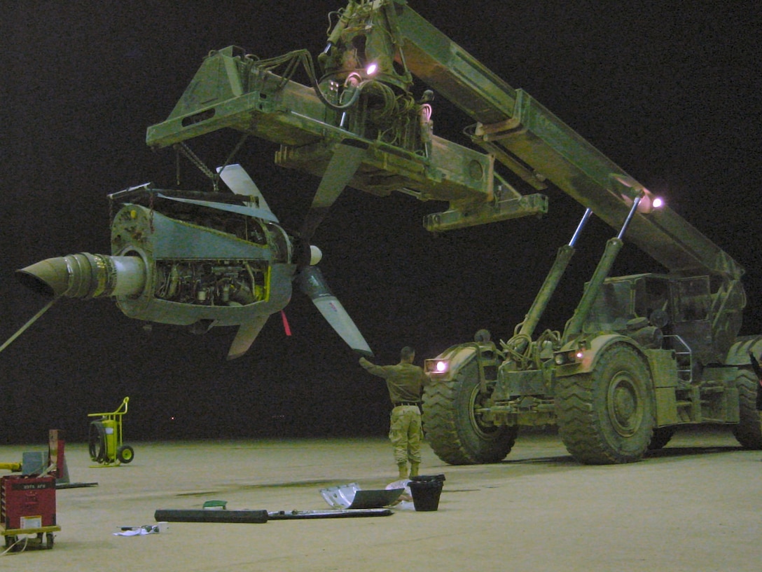 Tech. Sgt. Coby True, an instructor with the 373nd Training Squadron, Detachment 7, Hurlburt Field, Fla., removes and replaces a C-130 turboprop engine while deployed at Al Muthana Air Base, Iraq. Sergeant True was part of the Coalition Air Force Transition Team, Multinational Security Transition Command, assisting in the establishment of the new Iraqi Air Force. (U.S. Air Force photo).
