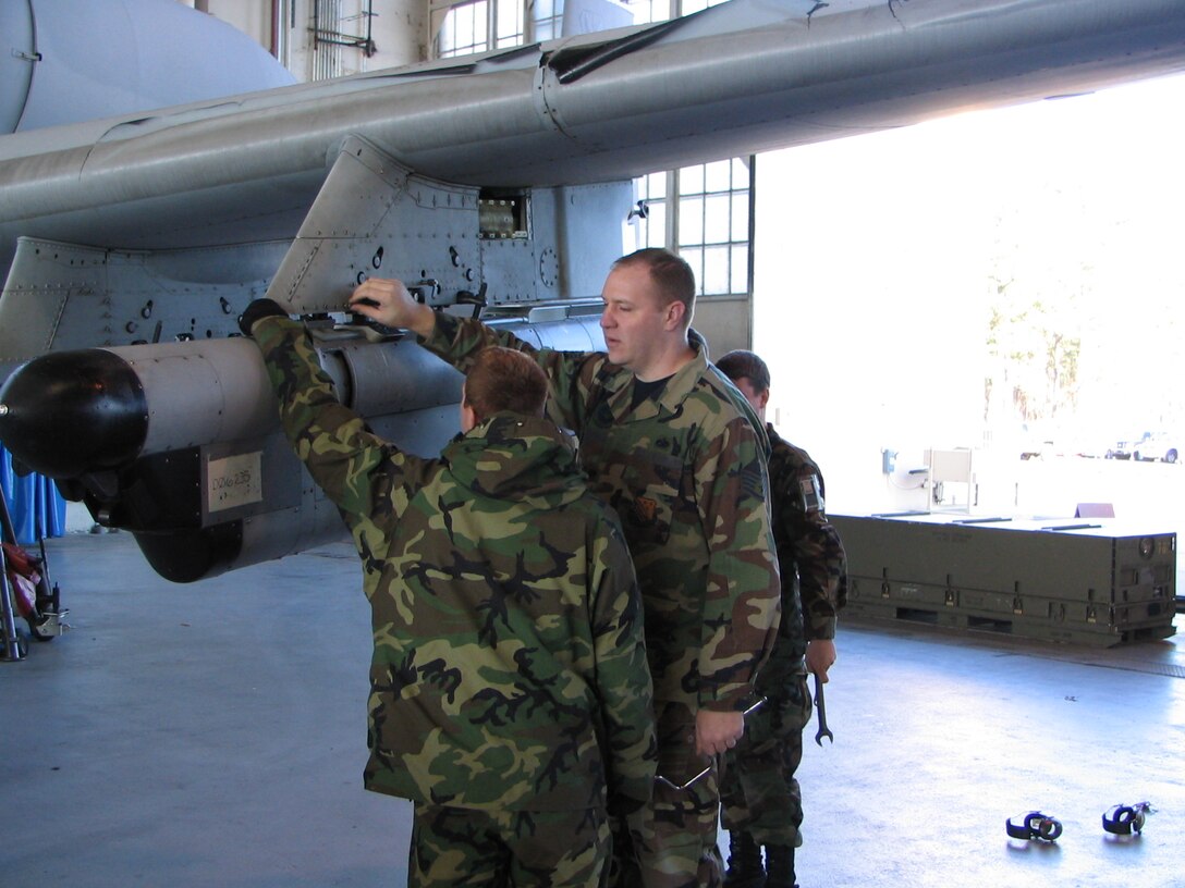 Staff Sgt. Anthony Vanderpohl is an A-10 avionics instructor at Detachment 2 at Pope Air Force Base, N.C. Here, he conducts a hands-on objective with students on jamming pod installation. (U.S. Air Force photo).