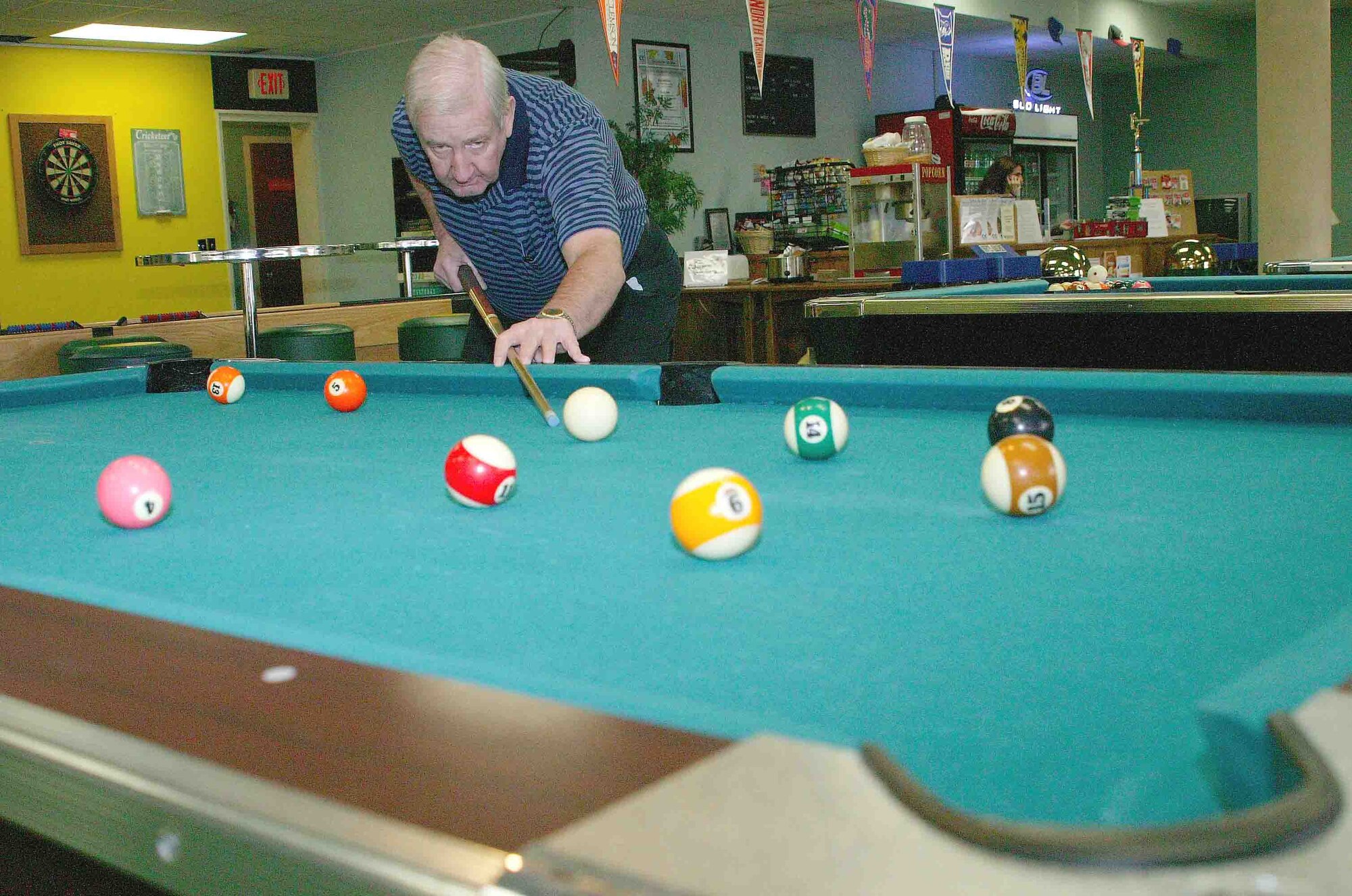 SHAW AIR FORCE BASE, S.C.-- Retired Air Force Staff Sgt. Lake Erskine Jr. enjoys a billiards game Nov. 8 at the community center. Sergeant Erskine has been playing pool for 18 years. The community center has pool and pingpong tables, darts, chess, video games, air hockey and shuffleboard for members to use. (U.S. Air Force photo/Senior Airman John Gordinier)