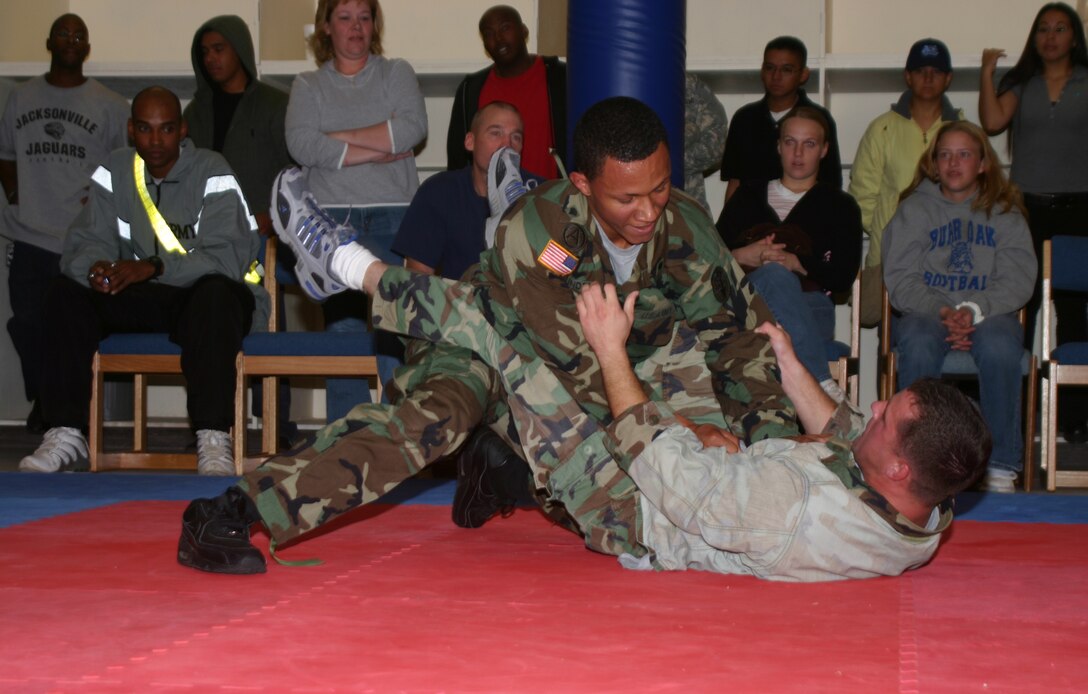 Tracy Underwood attempts to pin opponent Shawn Nunley at the Army Combatives Program Tournament Saturday. The Army Combatives Program was instituted to help prepare Soldiers for what they may face in a deployed environment. (U.S. Air Force photo/Airman Jacob Corbin)