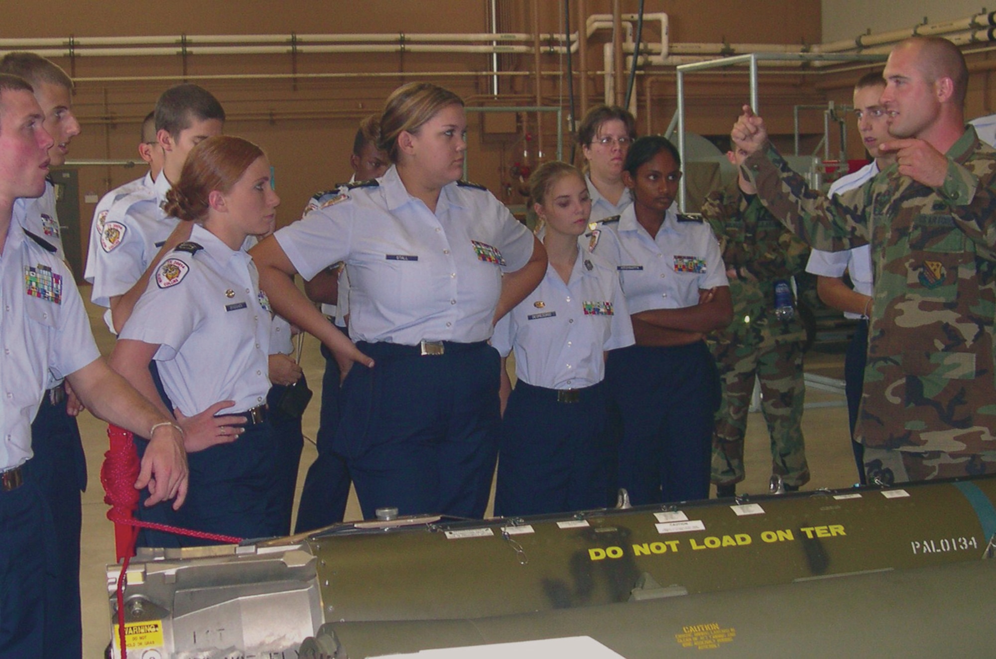 Tech. Sgt. Jeremy Stauty, an aircraft armament systems instructor at the 363rd Training Squadron, provides some instruction on bombs to Klein Collins High School Junior ROTC cadets Oct. 26. (U.S. Air Force photo/John Ingle)