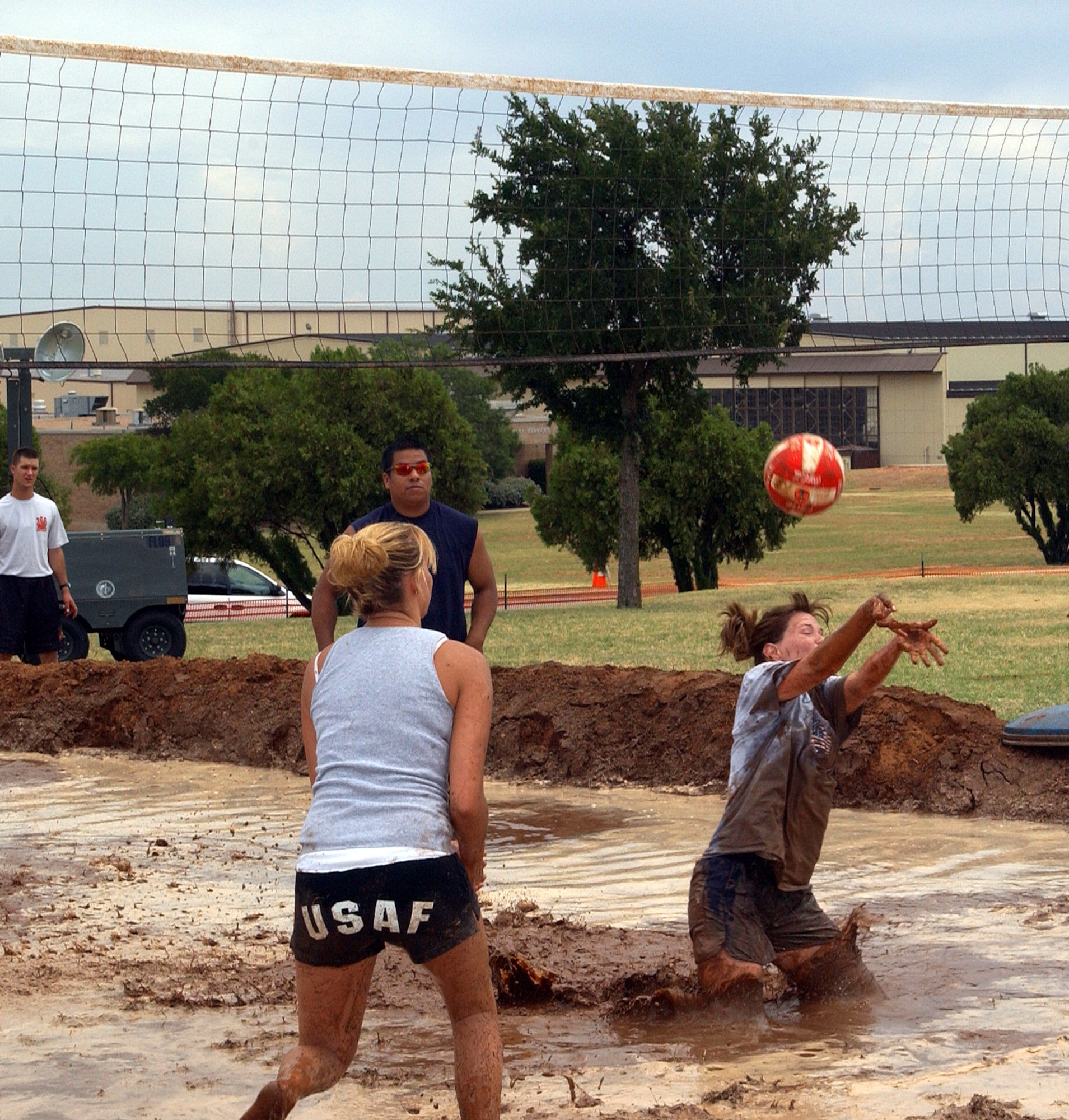 Kenda Poole, from the 82nd Training Group, dives into the mud to make a quick save during the mud volleyball tournament at Freedom Fest July 4. The tournament was one of numerous events offered during the celebration.  (U.S. Air Force photo/Lou Anne Sledge).