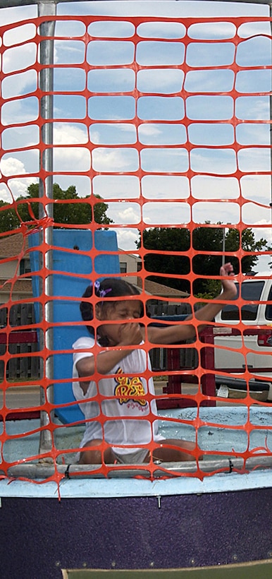 Several organizations set up shop during Freedom Fest July 4 to provide entertainment and games for festival-goers. Sheppard’s youth center operated a dunking booth to raise funds for future youth center activities. Kiera Mirich-Holder holds her nose as a lucky contestant hit the bulls eye. She is the daughter of Tech. Sgt. Michael Holder and Angela Mirich-Holder.  (U.S. Air Force photo/Sandy Wassenmiller).