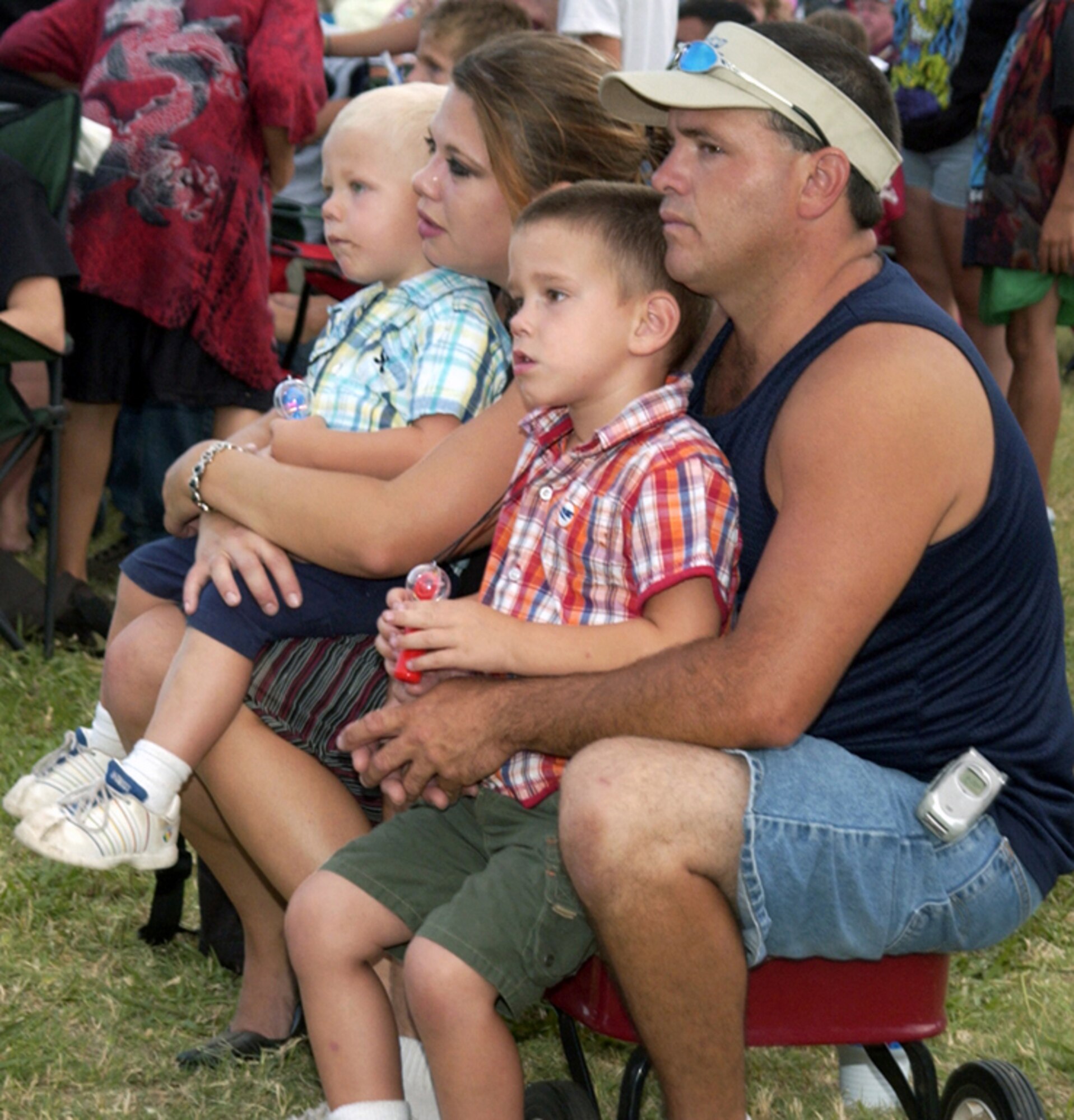 A family listens to a band during the Battle of the Bands competition at Freedom Fest 2006.  (U.S. Air Force photo/Sandy Wassenmiller).
