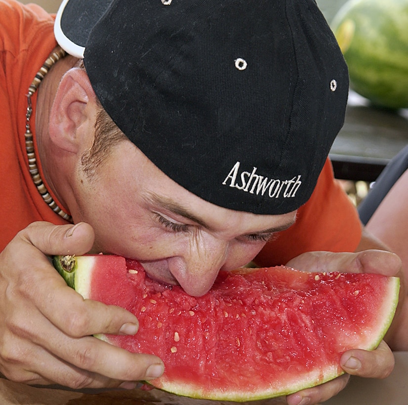 A hungry man digs into a juicy watermelon during Freedom Fest 2006's watermelon eating contest.  (U.S. Air Force photo/Sandy Wassenmiller).