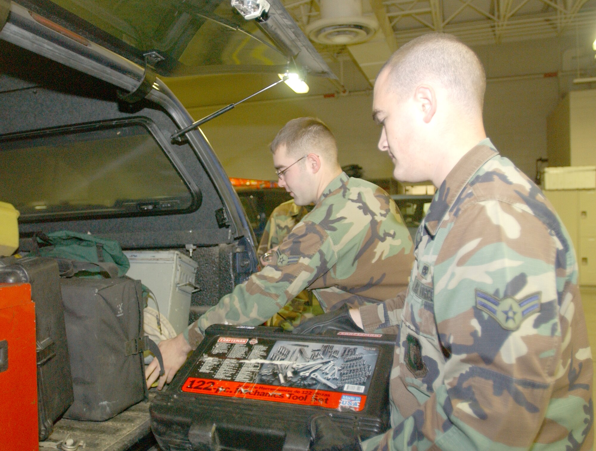 Airmen 1st Class Wesley Stallard and Cameron McMulllen, 5th Communications Squadron, load tools and other supplies into a vehicle Monday as part of the 91st Space Wing?s missile standardization evaluation and training assessment by 20th Air Force. An MSET assesses missile operations, maintenance, security and communications. (photo by Airman Sharida Bishop)                      