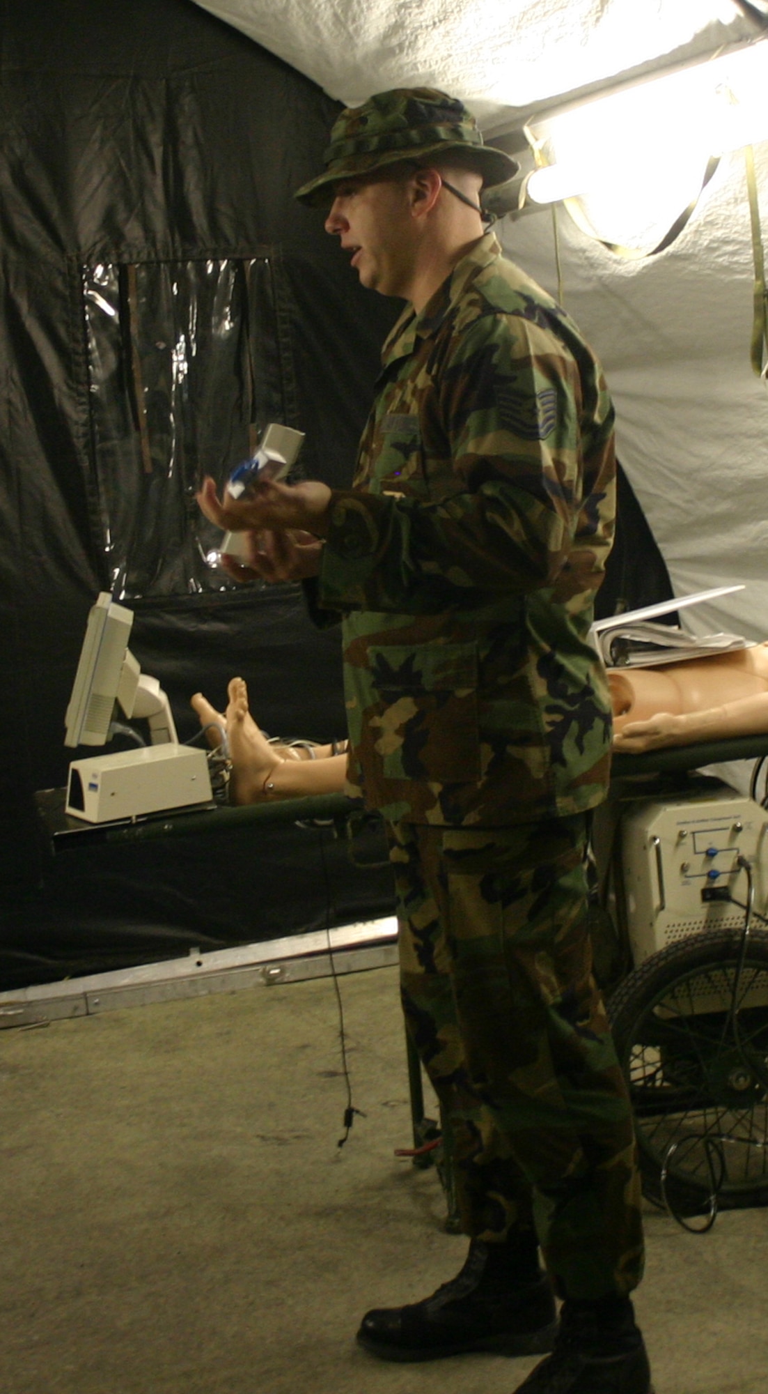 Tech. Sgt. Brian Westington of the 381st Training Squadron instructs medical readiness students on the use of a field blood gas analyzer. (U.S. Air Force photo/Robert Fox).