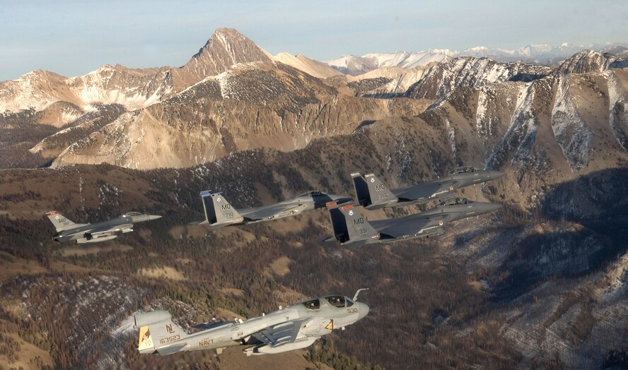 A five-ship formation, flying over the Idaho Sawtooth Mountains Nov. 1, comprised two F-15E Strike Eagles, an F-15 Eagle, an F-16 Fighting Falcon and an EA-6B Prowler. (U.S. Air Force photo/Master Sgt. Kevin J. Gruenwald) 