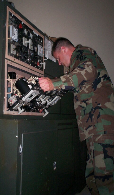 Staff Sgt. Chuck Paulson inspects a control panel at the 366th Training Squadron's Bare Base Power course. (U.S. Air Force photo/Robert Fox)