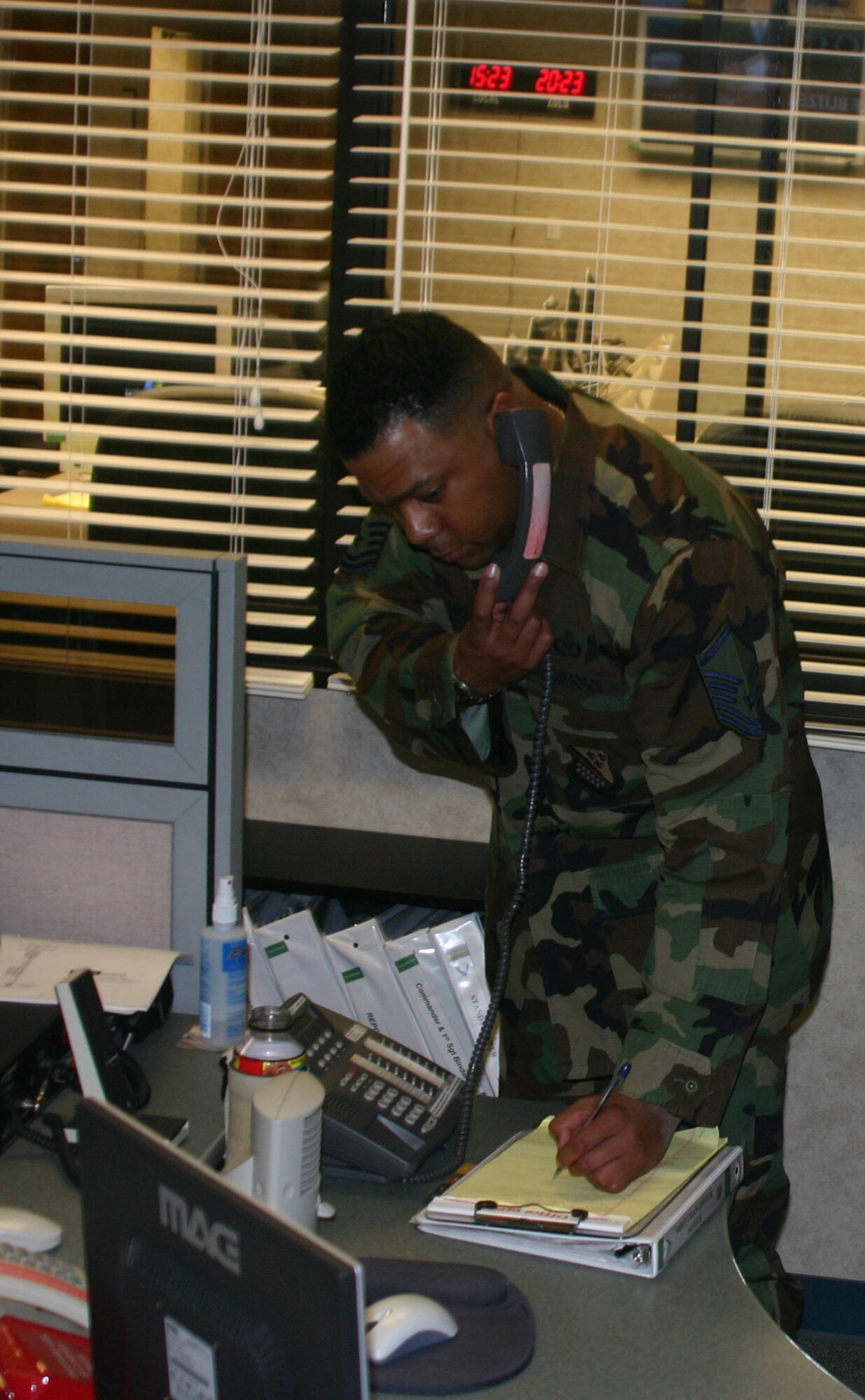 Master Sgt. Michael Williams logs a phone call Tuesday at the base’s command post. (U.S. Air Force photo/John Ingle).