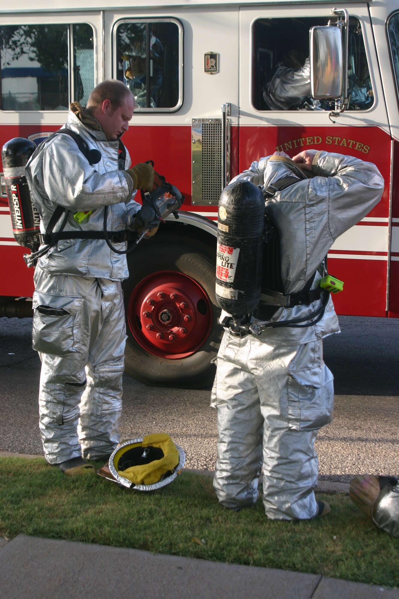 Firefighters prepare to provide assistance during an exercise Wednesday. A possible "terrorist" drove through Sheppard's hospital gate before exploding his car at the southeast corner of the ocmmunity center.  (U.S. Air Force photo/John Ingle)