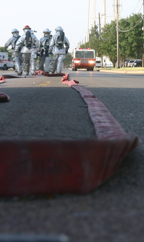 Sheppard Fire Department firefighters carry a car bomb "victim" to a waiting ambulance Wednesday morning during a mass casualty exercise at the community center. (U.S. Air Force photo/John Ingle)