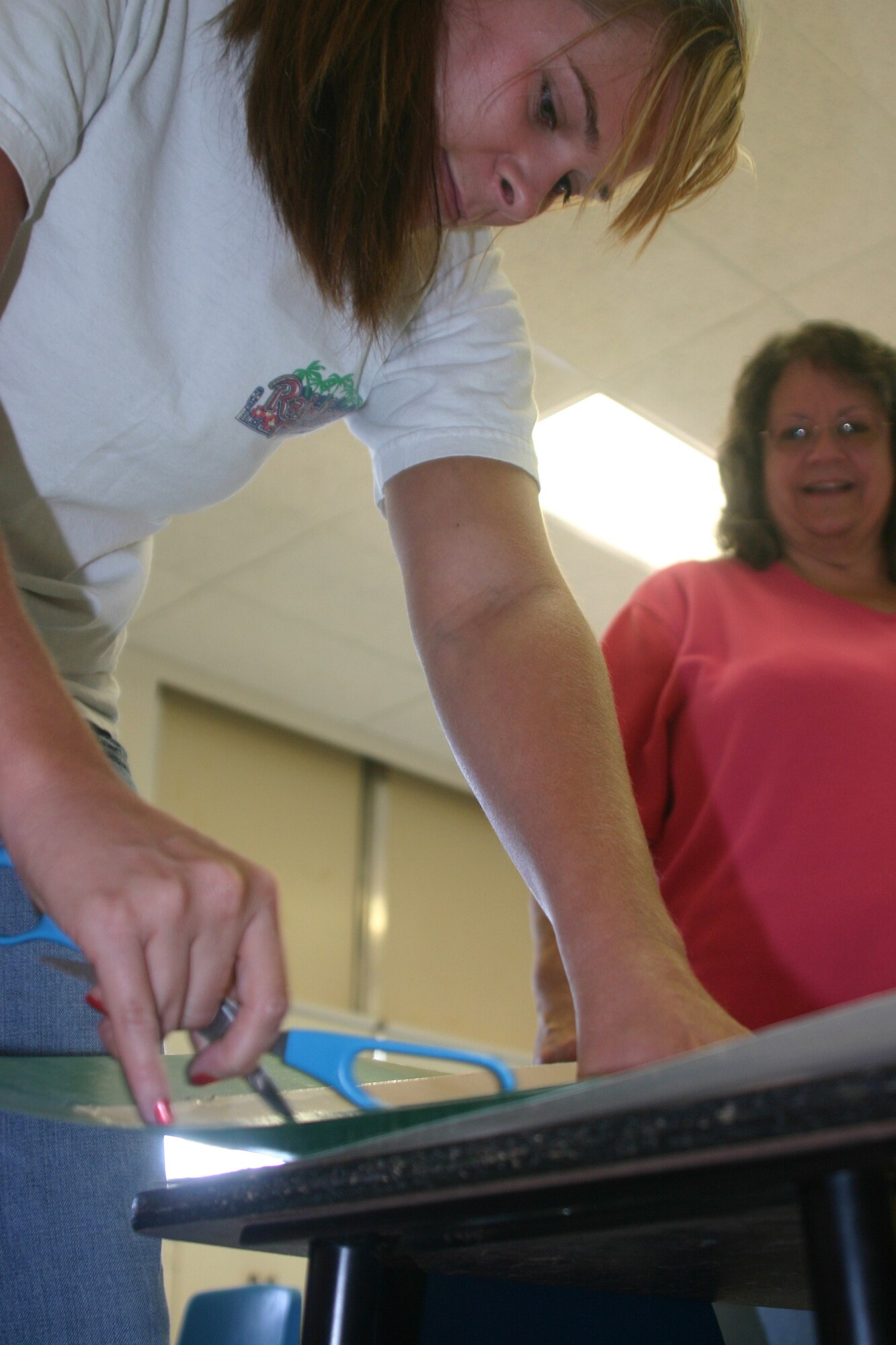 Sheppard children head back to the classroom Monday as the 2006-2007 schoolyear begins. Jessica Ross, left, prepares a visual aid Tuesday morning to prepare her room for her first class. Vickie Henderson, right, will mentor the first-year teacher. (U.S. Air Force photo/John Ingle)