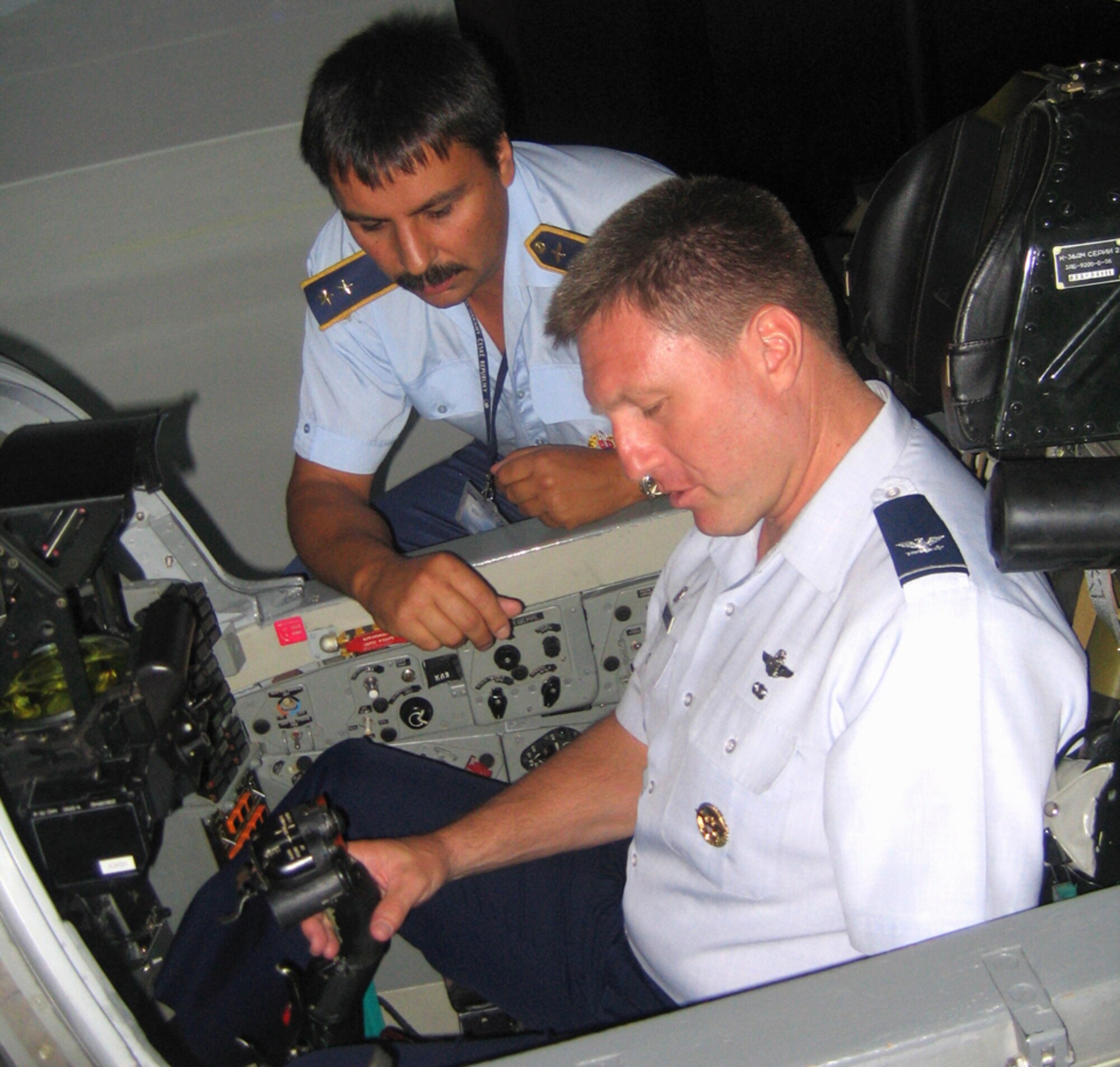 80th Flying Training Wing Commander Col. Jeffrey Kendall sits inside a flight simulator during hsi visit to one of the newest NATO partners, Slovakia, as a Slovakian pilot provides instruction on the country's training device. (Courtesy photo)
