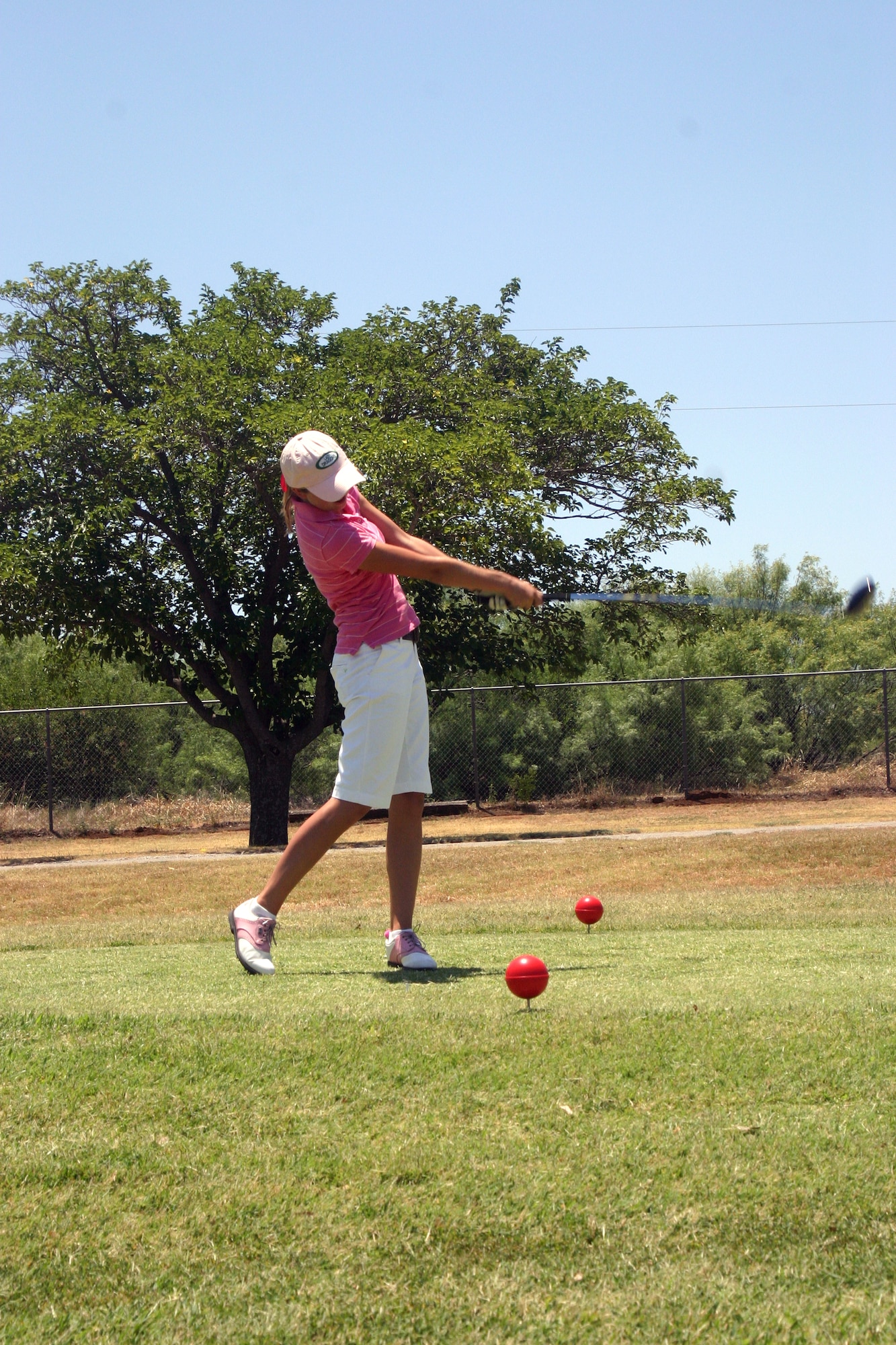 Elizabeth Stone, 15 years old, tees off at her first hole of the Texas-Oklahoma Junior Golf Tournament Monday. (U.S. Air Force photo/Airman Jacob Corbin).