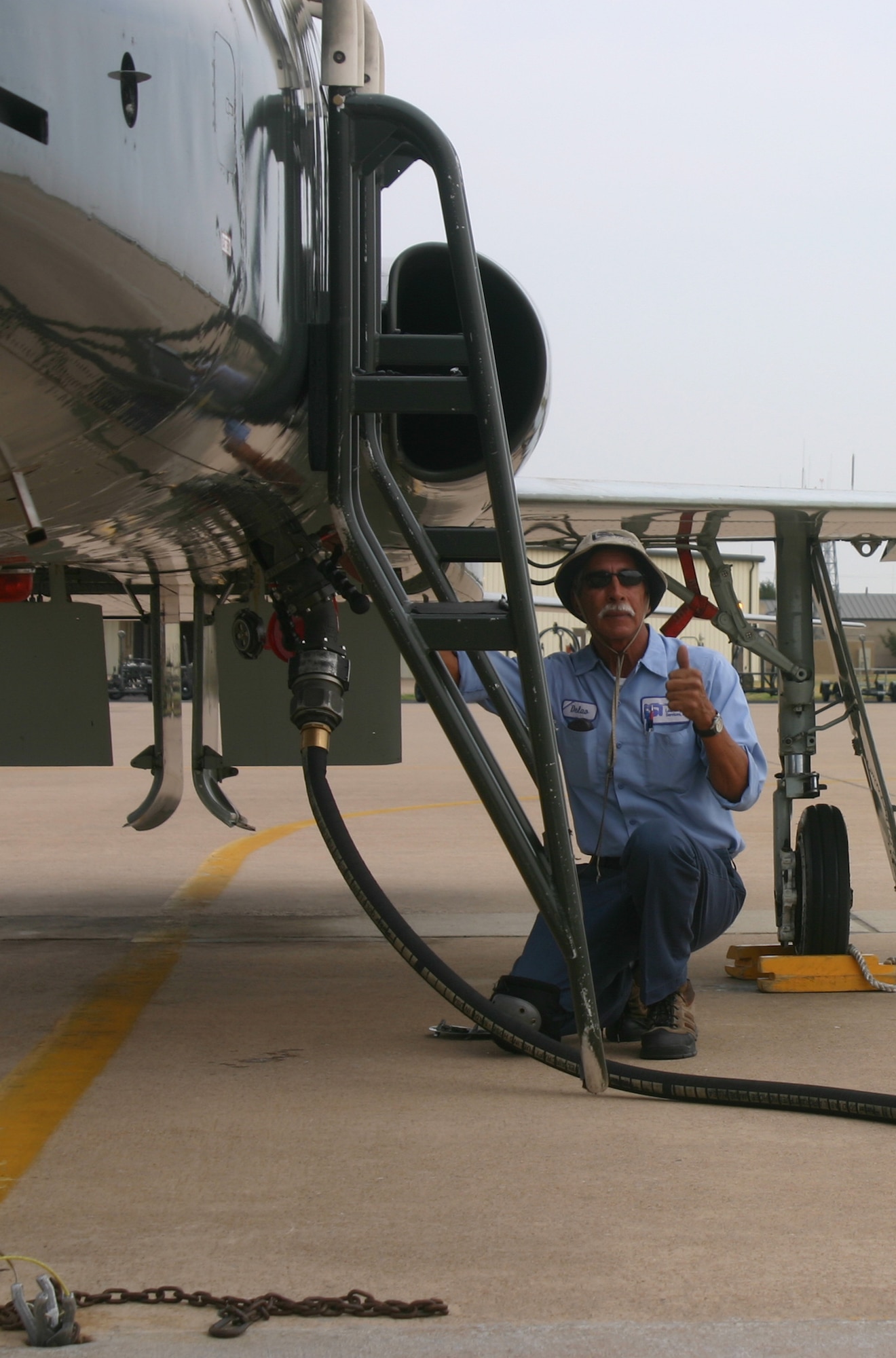 Jessie Dalao, a refuel driver, gives the OK to begin fueling a T-38 Talon.  (U.S. Air Force photo/Robert Fox)