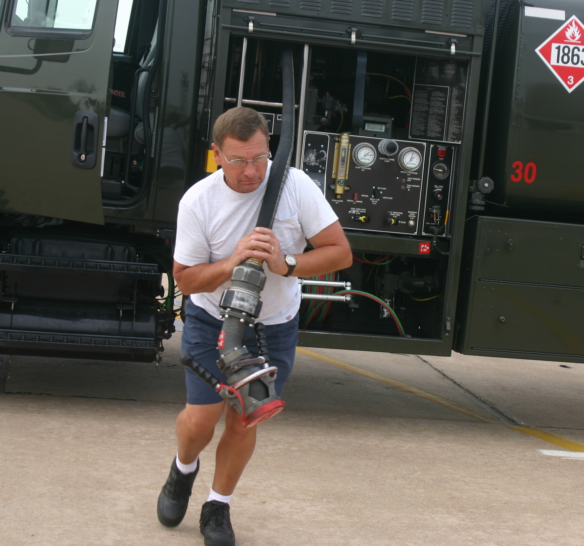 Richard Childers prepares to refuel at T-38 Talon. (U.S. Air Force photo/Robert Fox)