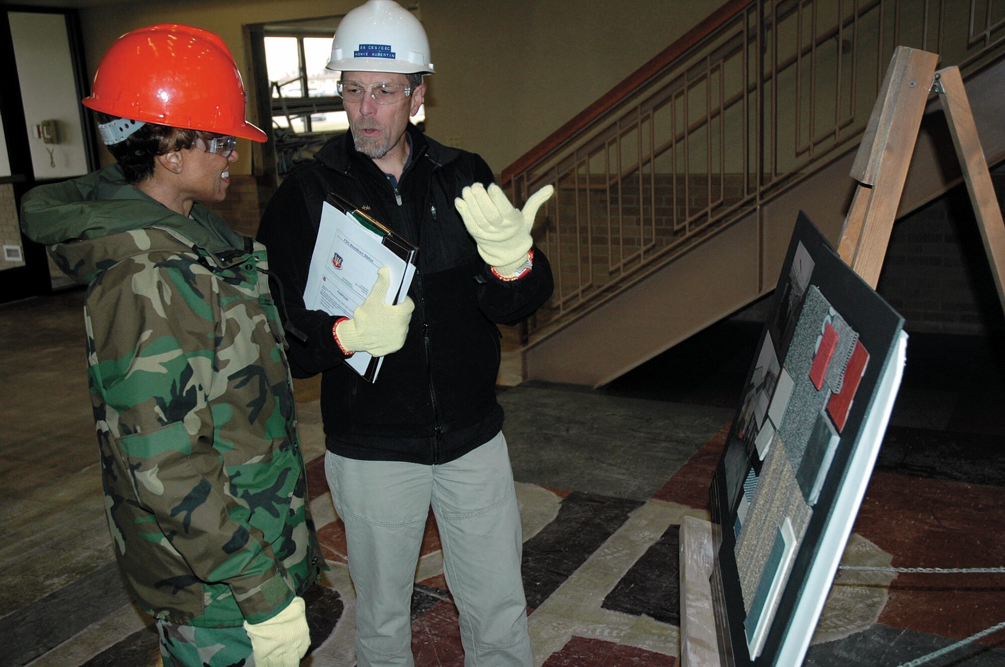 Howie Aubertin, 28th Civil Engineering Squadron engineering flight chief, briefs Col. Renita Alexander, 28th Mission Support Group commander, on the progress of the education center transforming to the new Air Force Financial Services Center. The classes previosuly held in the education center have been dispersed across the squadrons at Ellsworth, the Rushmore Center and in Douglas High School.