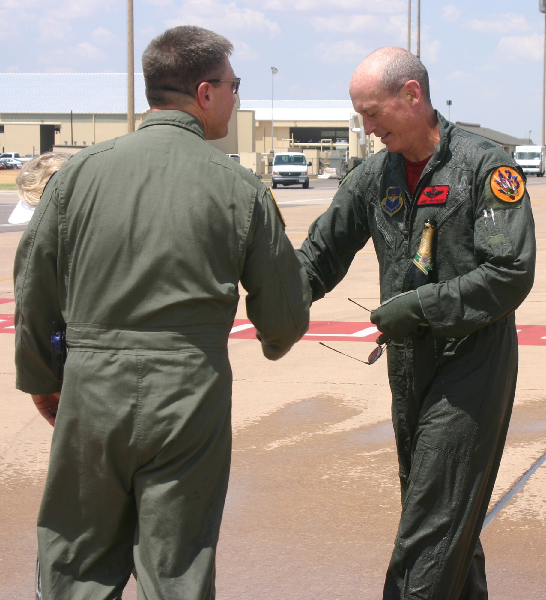 Brig. Gen. James Whitmore, right, is congratulated by 80th Flying Training Wing Commander Col. Jeffrey Kendall following the general's final flight at Sheppard. (U.S. Air Force photo/John Ingle)
