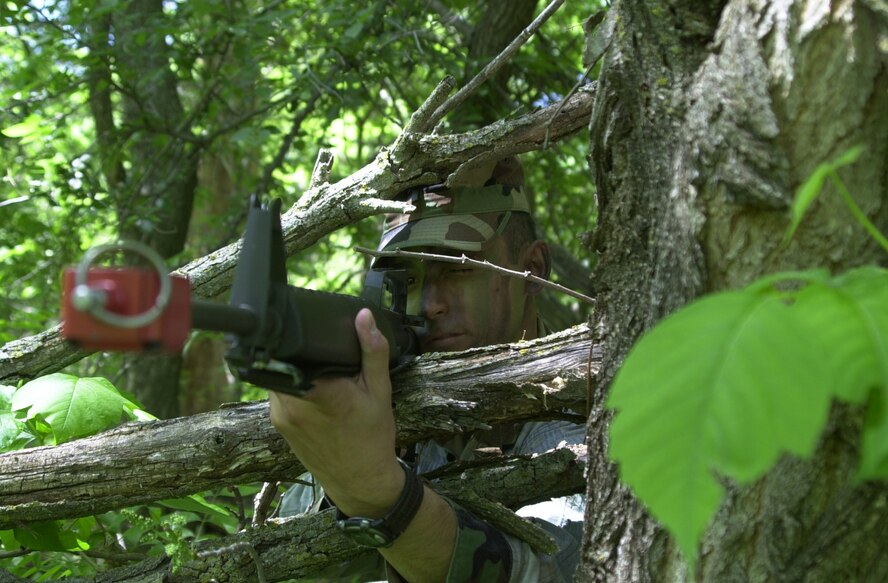 A Combat Readiness Course participant scans the perimeter for enemy forces while staying concealed. The week-long course teaches concealment techniques, convoy training and the ability to survive and operate.(Courtesy photo)