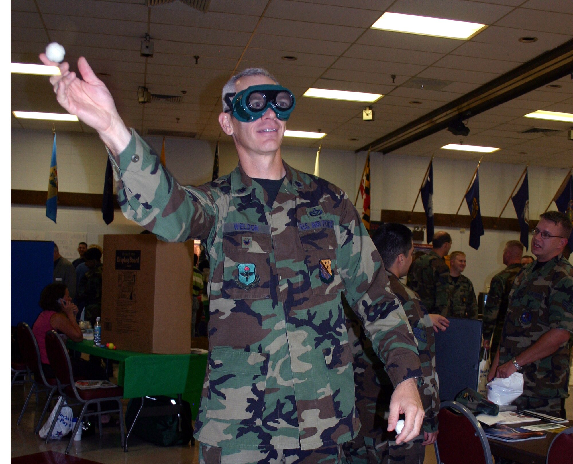 Lt. Col. Kenny Weldon, 82nd Mission Support Group deputy commander, throws a sticky ping pong ball at a target while wearing vision-altering goggles at the Safety Day Fair May 26. The goggles simulate a person’s perception while under the influence of alcohol. (U.S. Air Force photo/Senior Airman Jacque Lickteig).