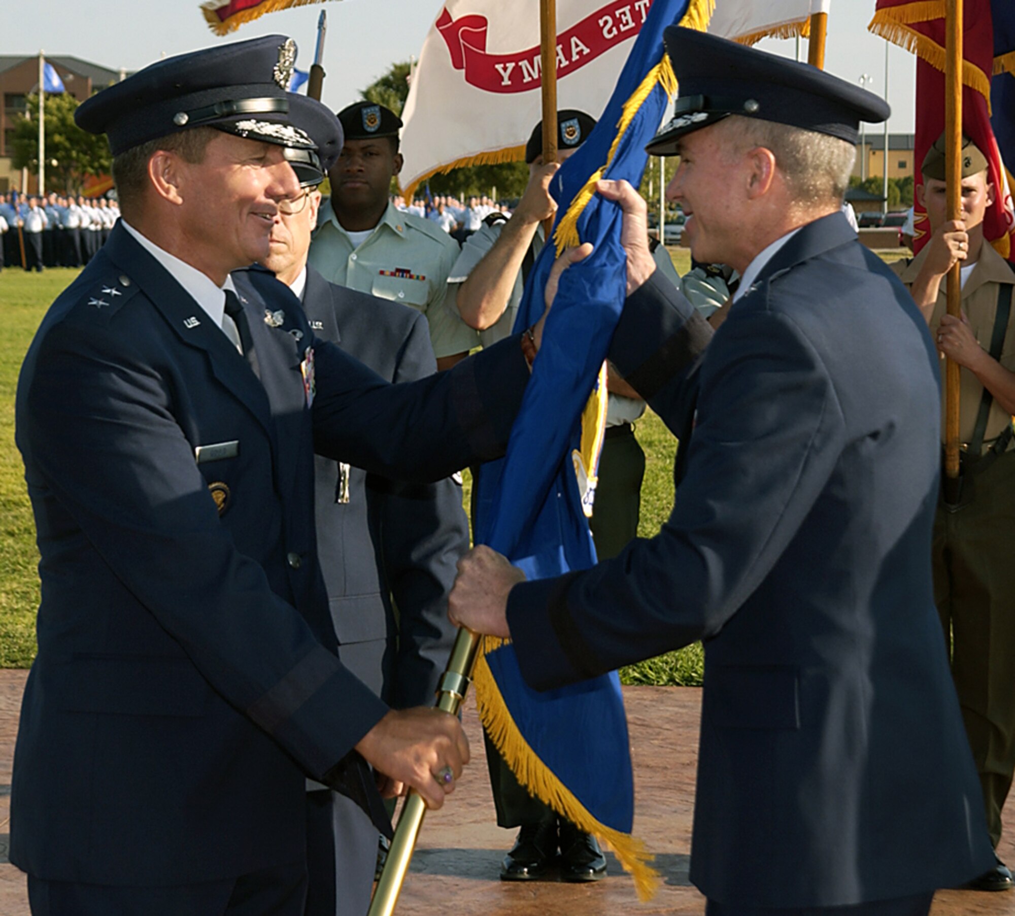 Brig. Gen. Richard Devereaux takes the flag of the 82nd Training Wing Aug. 25 from Maj. Gen. Michael Gould, 2nd Air Force commander. General Devereaux took command from Brig. Gen. James Whitmore during the early morning ceremony. (U.S. Air Force photo/Sandy Wassenmiller)