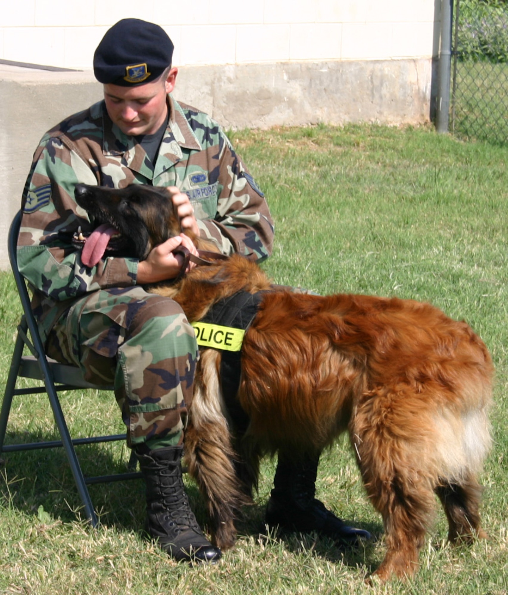 Staff Sgt. Thomas Butler, 82nd Security Forces Squadron, shows Charque, his military working dog, some affection during the dog’s retirement ceremony May 25. (U.S. Air Force photo/Staff Sgt. Jennifer Baxter).