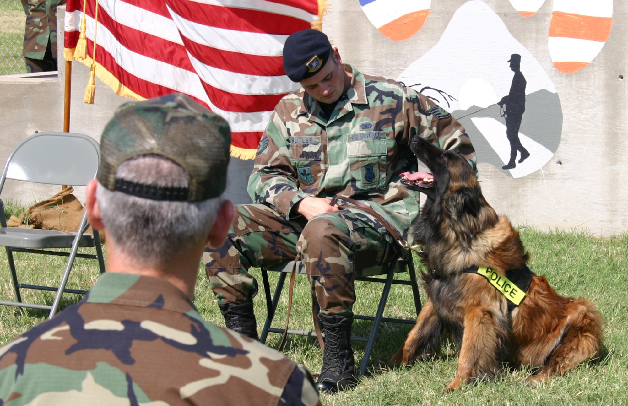 Staff Sgt. Thomas Butler, from the 82nd Security Force Squadron, pets Charque, his military working dog, during the dog’s retirement ceremony May 25. Charque served for eight years. (U.S. Air Force photo/Staff Sgt. Jennifer Baxter).