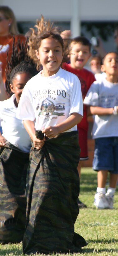 Nicole Evans, a first grade student at Sheppard Elementary, hops in a potato-sack race Friday. (U.S. Air Force photo/Airman Jacob Corbin).