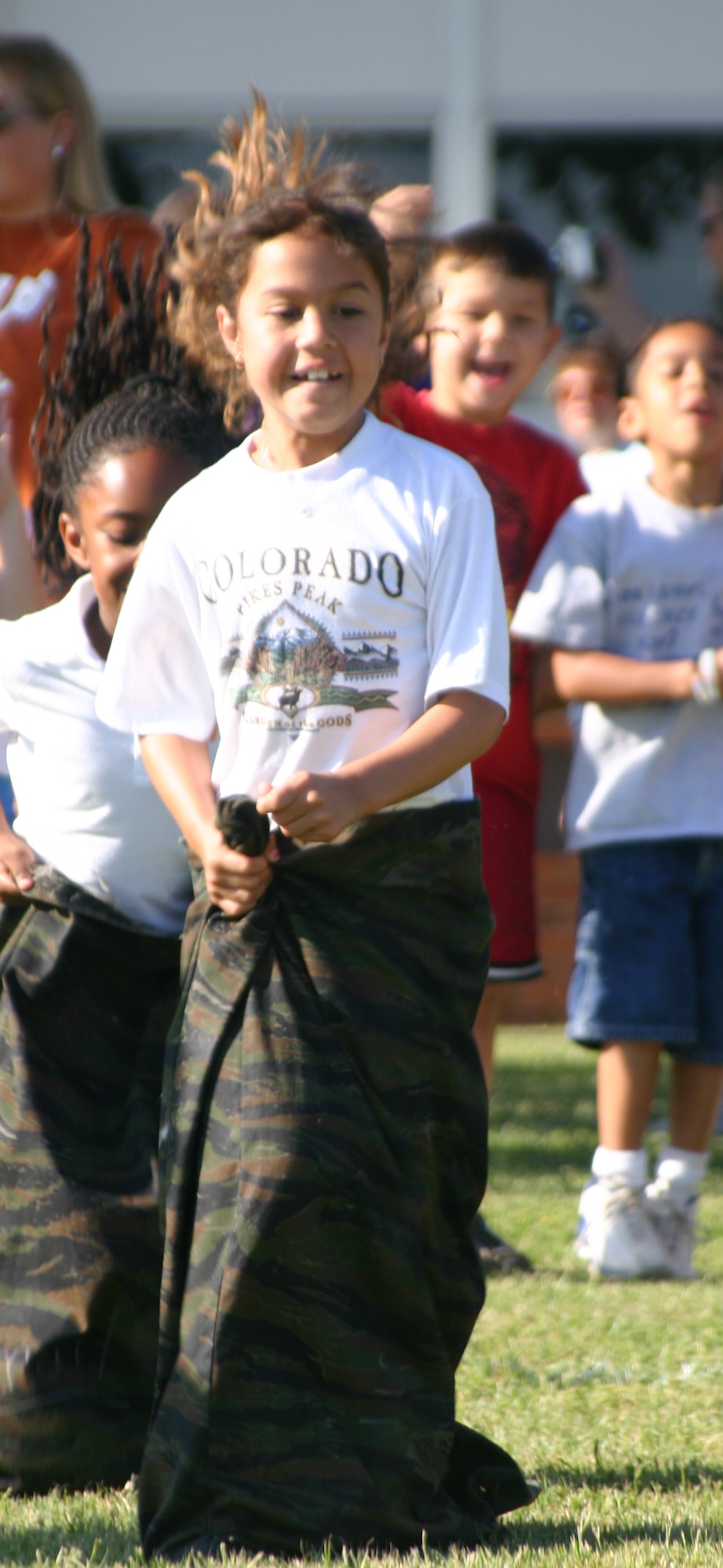 Nicole Evans, a first grade student at Sheppard Elementary, hops in a potato-sack race Friday. (U.S. Air Force photo/Airman Jacob Corbin).