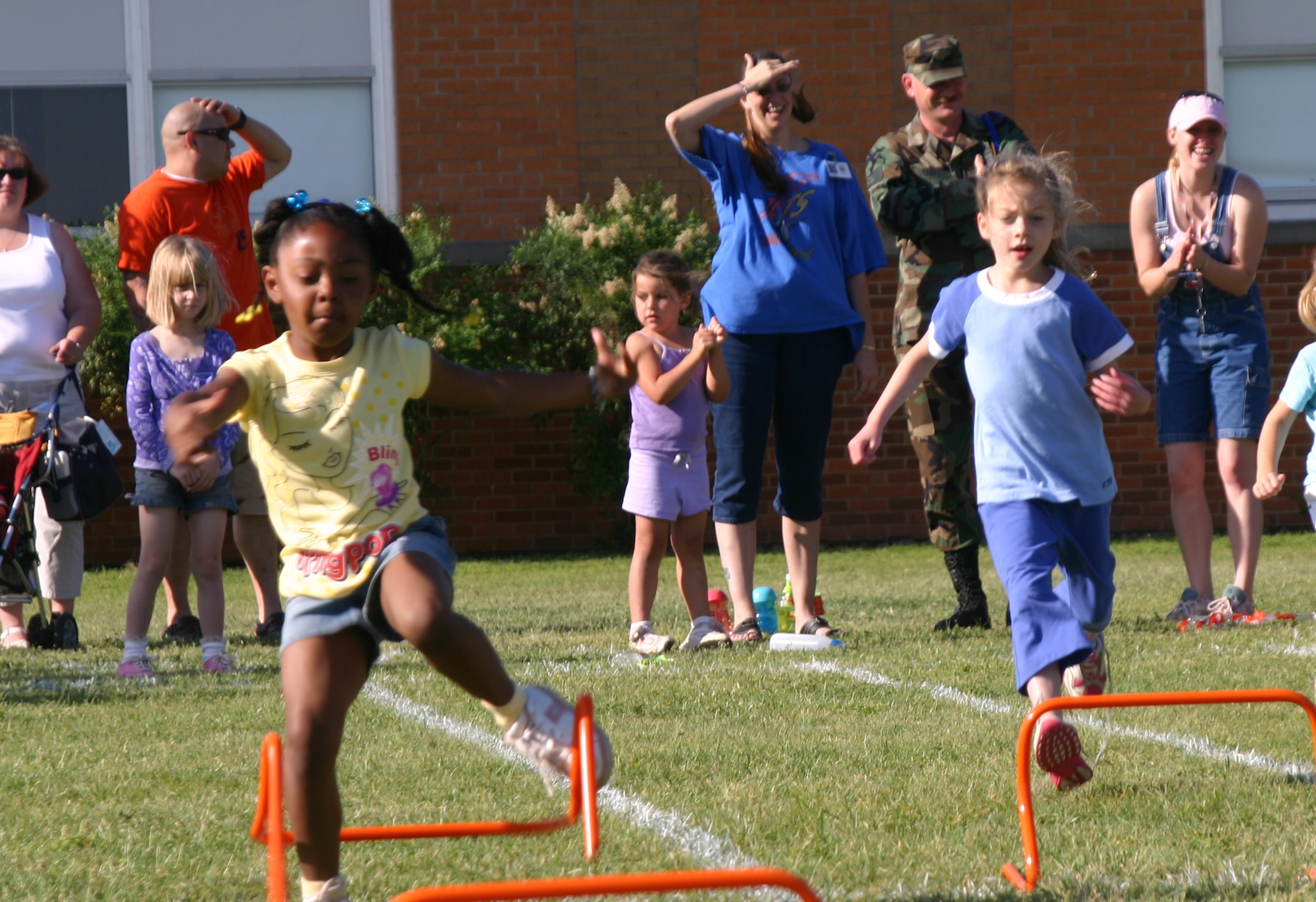 Heaven Terrel and Cameryn Norris, kindergarten students at Sheppard Elementary, participate in the hurdles event Friday. (U.S. Air Force photo/Airman Jacob Corbin).