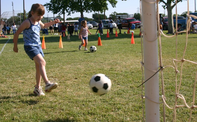 Abigail Mills, a Sheppard Elementary student in Jennifer Godby’s kindergarten class, participates in the soccer shoot event at Sheppard Elementary’s field day on Friday. (U.S. Air Force photo/Airman Jacob Corbin).
