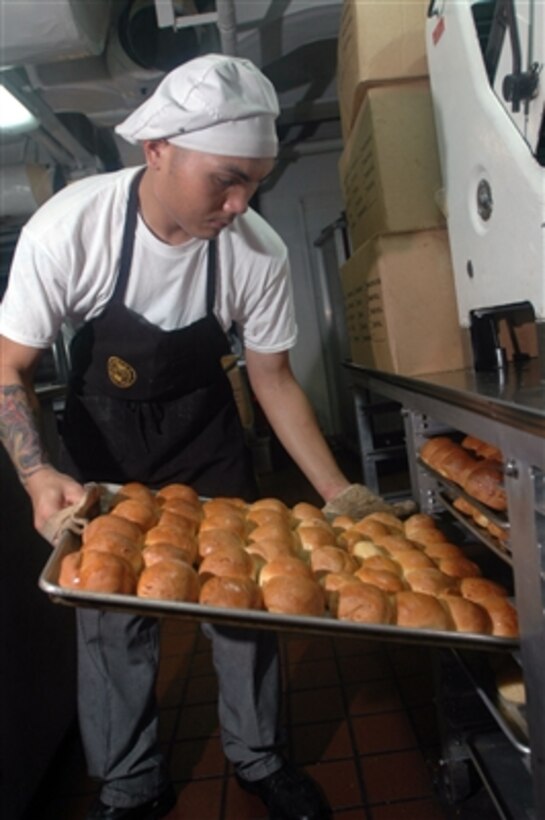 Seaman Mark Andaya prepares fresh rolls for the evening meal in the aft galley of the aircraft carrier USS John C. Stennis (CVN 74) on Nov. 7, 2006.  Andaya is a U.S. Navy culinary specialist aboard the Stennis, which is currently the flagship for Commander, Carrier Strike Group 3.  