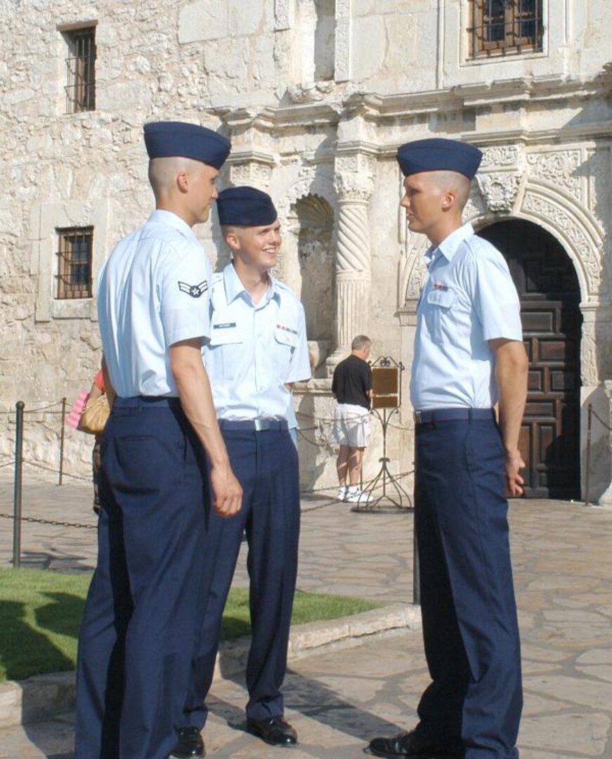 The Hatcher brothers, left to right, Airman First Class Logan and Airmen Basic Derek and Chaz, visited one of San Antonio's busiest tourist locations, the Alamo, following their graduation from Basic Training Nov. 10. The three brothers all joined the Air Force from Fort Worth, Texas. (U.S. Air Force photos/Alan Boedeker)