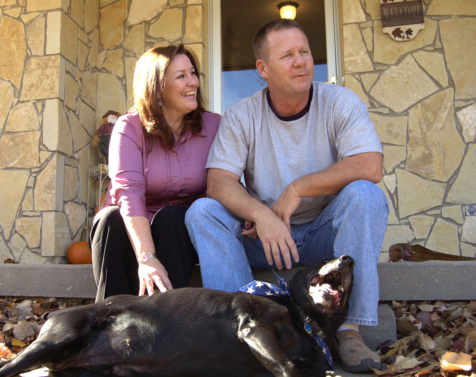 Chief Master Sgt. John Gebhardt and his wife, Mindy, share a quiet moment with their dog, Cole, at their home in Wichita, Kan. The chief is the superintendent of 22nd Wing Medical Group at McConnell Air Force Base, Kan. He has recently gained worldwide attention for a photo of him comforting an Iraqi child. (U.S. Air Force photo/Staff Sgt. Jeremy Larlee)