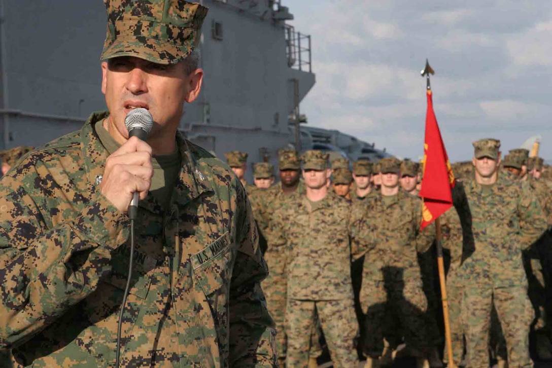 Colonel Ron Johnson addresses the Marines of the 24th Marine Expeditionary Unit on the flight deck of the USS Iwo Jima on Nov. 10.::n::Johnson is the commanding officer of the 24th MEU and a native of Duxburry, Mass. The 24th MEU is returning home after a six-month deployment with the Iwo Jima Expeditionary Strike Group. (U.S. Marine Corps photo by Lance Corporal Joshua Lujan)