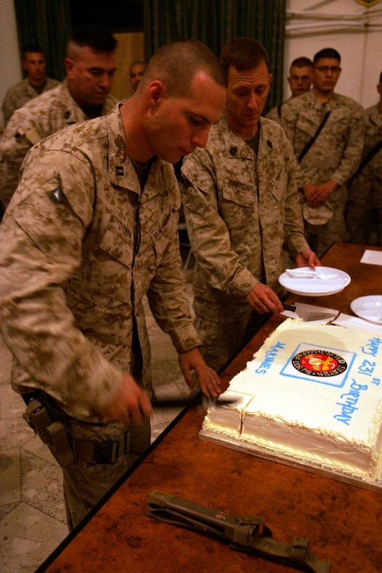 Capt. Sean P. Dynan, 30-year-old company commander for Headquarters and Service Company, 1st Battalion, 6th Marine Regiment, cuts the cake during a celebration of the Corps? 231st birthday at Camp Hurricane Point in Ar Ramadi, Iraq, on Nov. 10.