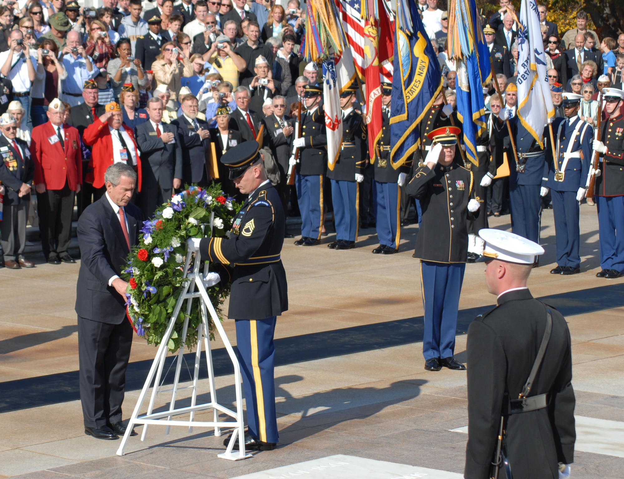 President George Bush lays a wreath at the Tomb of the Unknown Soldiers during a Veterans Day ceremony Nov. 11 at the Arlington National Cemetary in Arlington, Va. The Air Force Honor Guard formed a flight in attendance, along with each of the other four services, and carried the Air Force flag during the ceremony. (Air Force photo/Staff Sgt. Madelyn Waychoff)