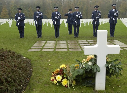 Honor guard members perform before the grave of Gen. George S. Patton during the Veterans Day ceremony at the Luxembourg American Cemetery and Memorial Nov. 11. The honor guard members are from the 52 Fighter Wing at Spangdahlem Air Base, Germany. (U.S. Air Force photo/Airman 1st Class Josie L. Kemp)