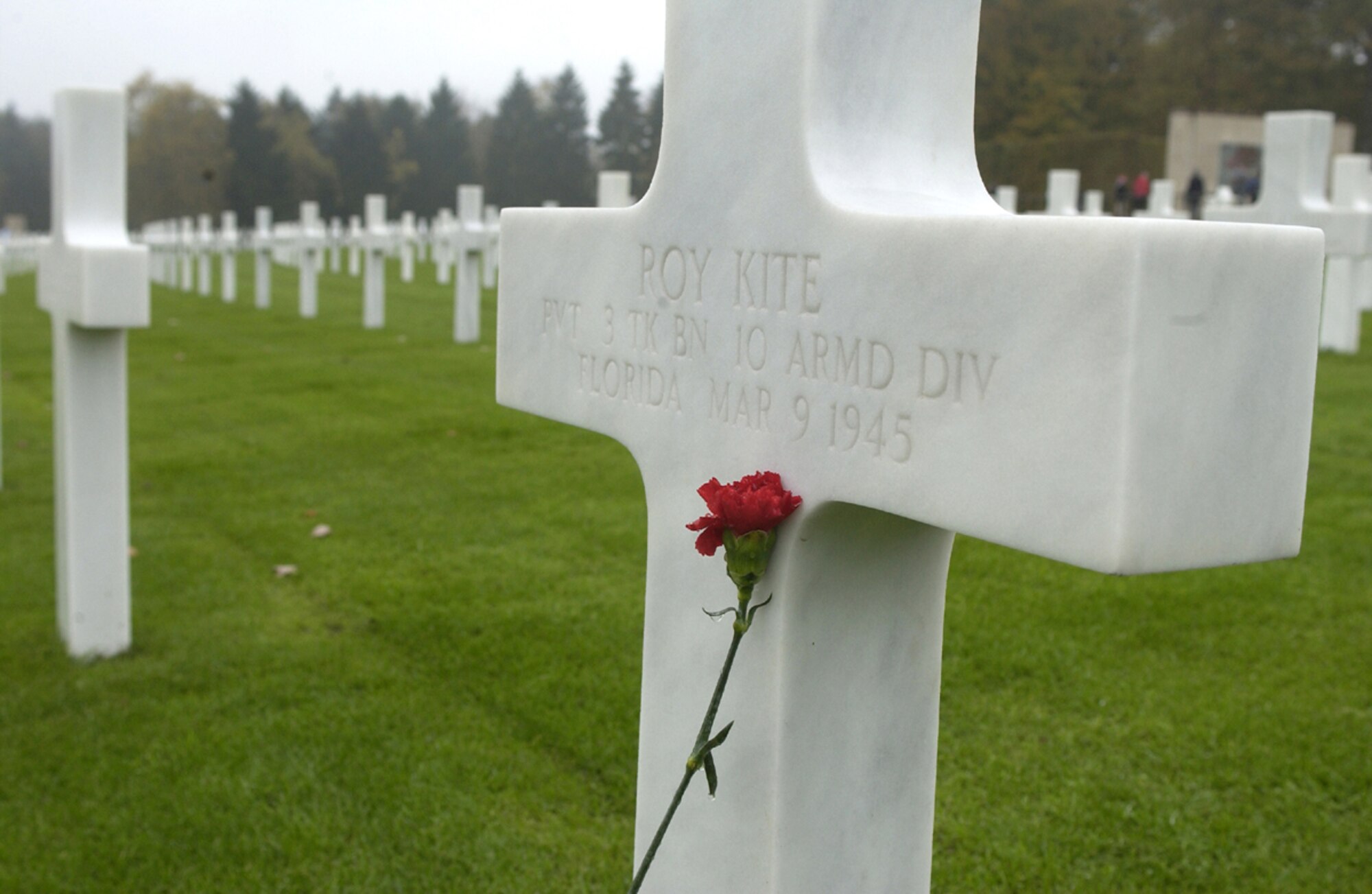 A red carnation placed on a cross at the Luxembourg American Cemetery and Memorial stands in remembrance of the fallen servicemen who were laid to rest there. (U.S. Air Force photo/Airman 1st Class Josie L. Kemp)