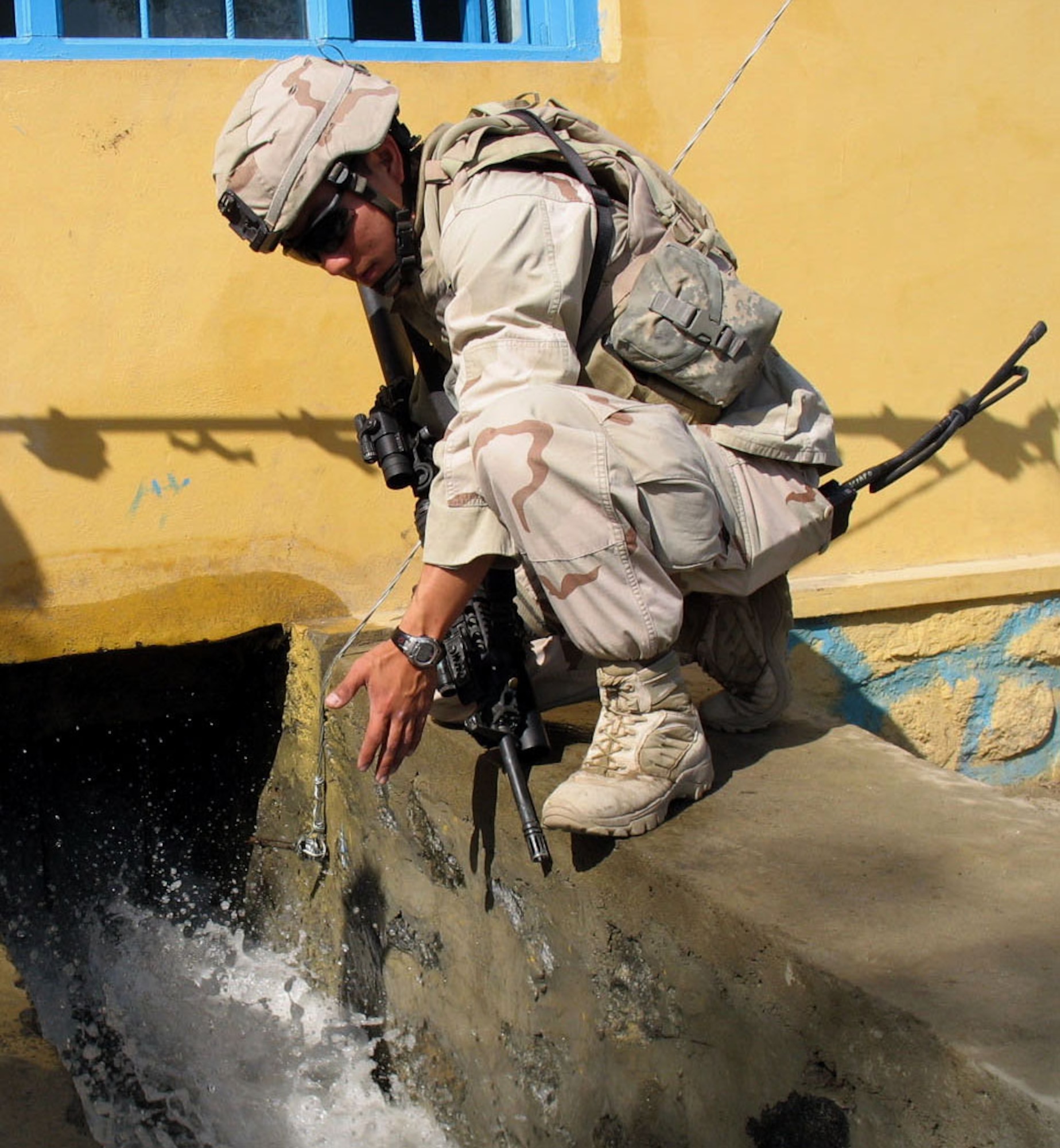MEHTAR LAM, Afghanistan -- An Airman observes water as it flows through the newly opened micro-hydroelectric power plant built by the provincial reconstruction team here. The new plant is capable of providing electricity to 300 homes in the area. (Air Force photo\Capt. Gerardo Gonzalez)  