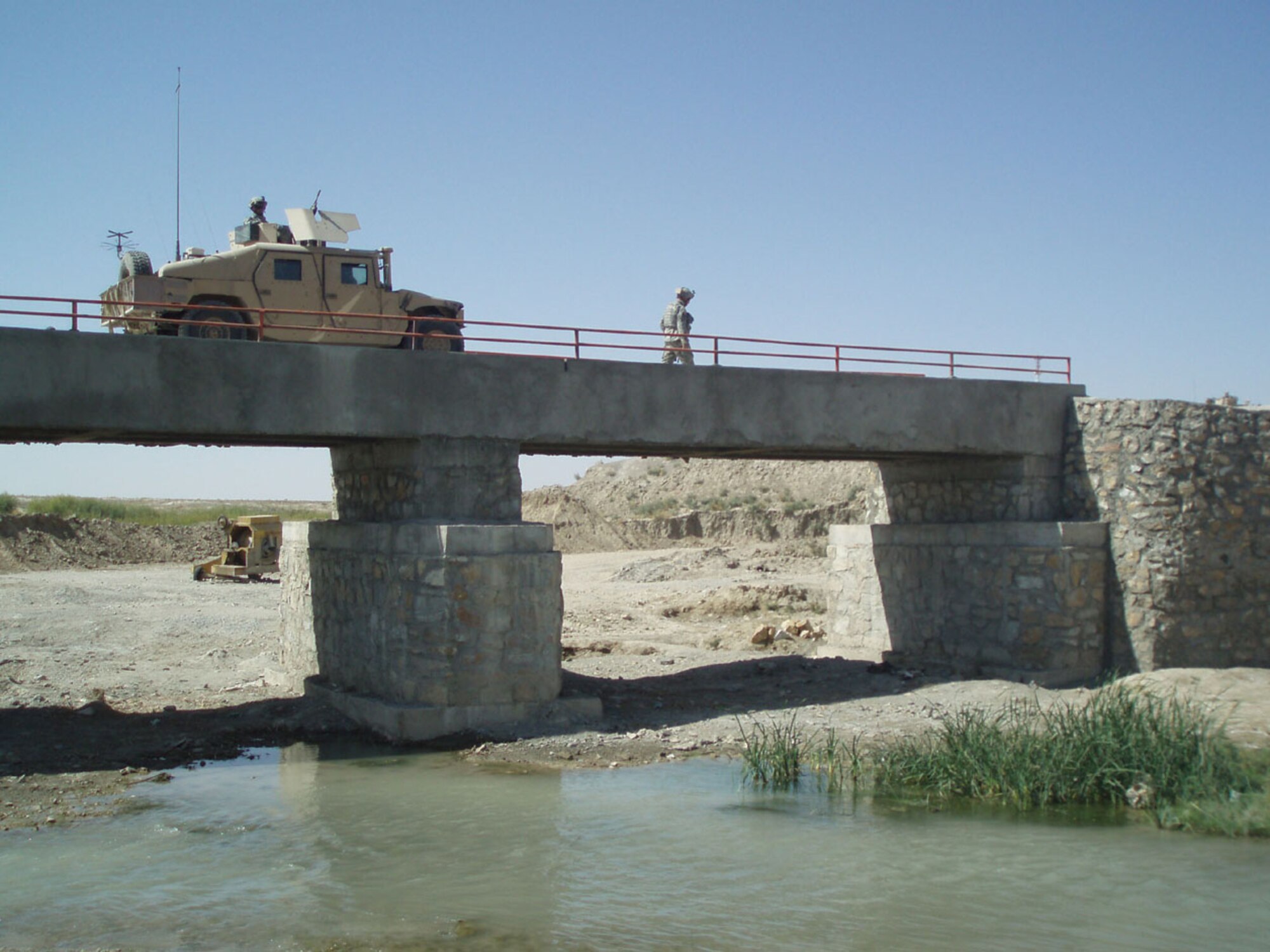 QALAT, Afghanistan -- A Humvee from the Qalat Provincial Reconstruction Team crosses a newly constructed bridge in the Zabul province, Afghnanistan. PRTs are a mix of civilian, U.S. military and Coalition members that try to promote conditions for self-sufficiency, enduring prosperity and a secure, stable environment.  (Air Force photo\ Capt. Kevin Tuttle)

