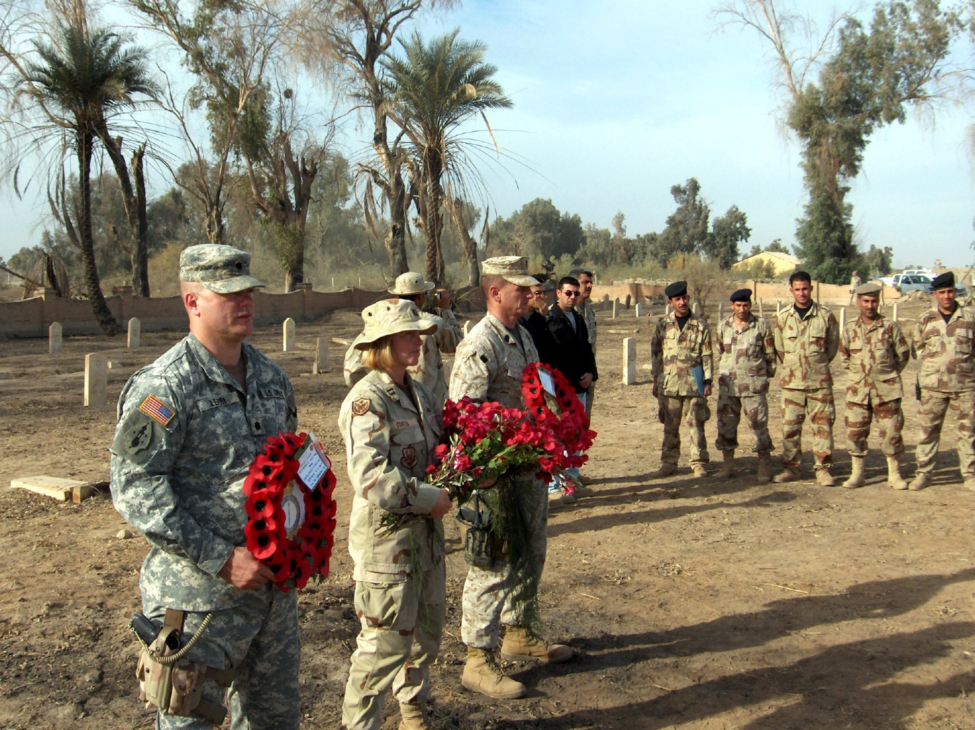 Capt. Jutta Cortes, center, led volunteer efforts in November 2005 to restore the Habbaniya cemetery in Iraq and organized the first official remembrance service there since 1959. The cemetery, located on the former British base, serves as the final resting place for many servicemembers and their families. The efforts by Captain Cortes led to a request by the RAF Habbaniya Association for her to join its British regiment in a remembrance service at The Cenotaph memorial in London's Whitehall Nov. 12. Captain Cortes is the deputy director of security forces for the 20th Air Force at F.E. Warren Air Force Base, Wyo. (Courtesy photo)