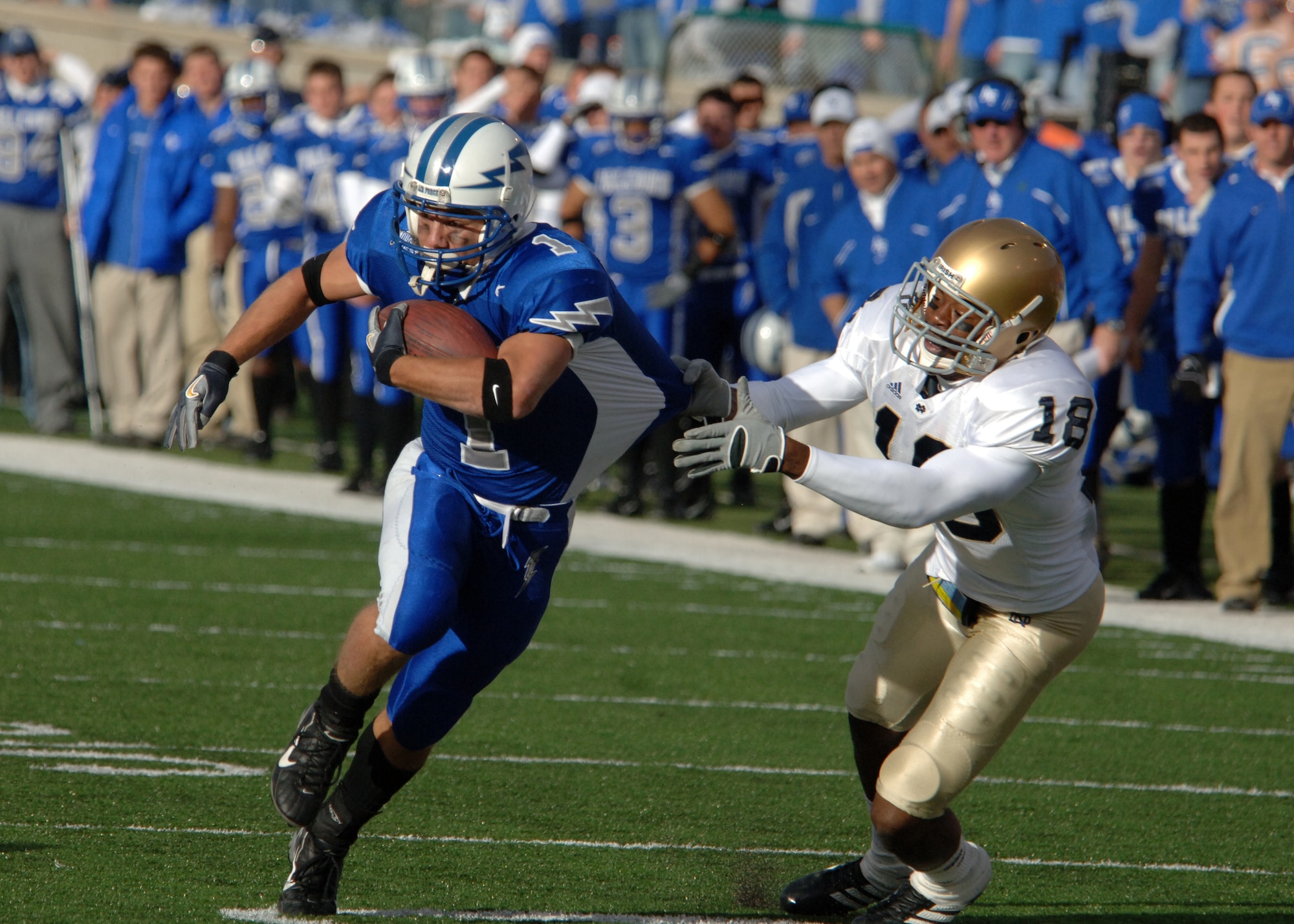 Air Force halfback Chad Hall nearly escapes the grasp of Notre Dame defensive back Chinedum Ndukwe Saturday. Hall let the Falcons in rushing with 72 yards, but the explosive Irish offense proved too much for Air Force.  Notre Dame won, 39-17. (U.S. Air Force photo/John Van Winkle)